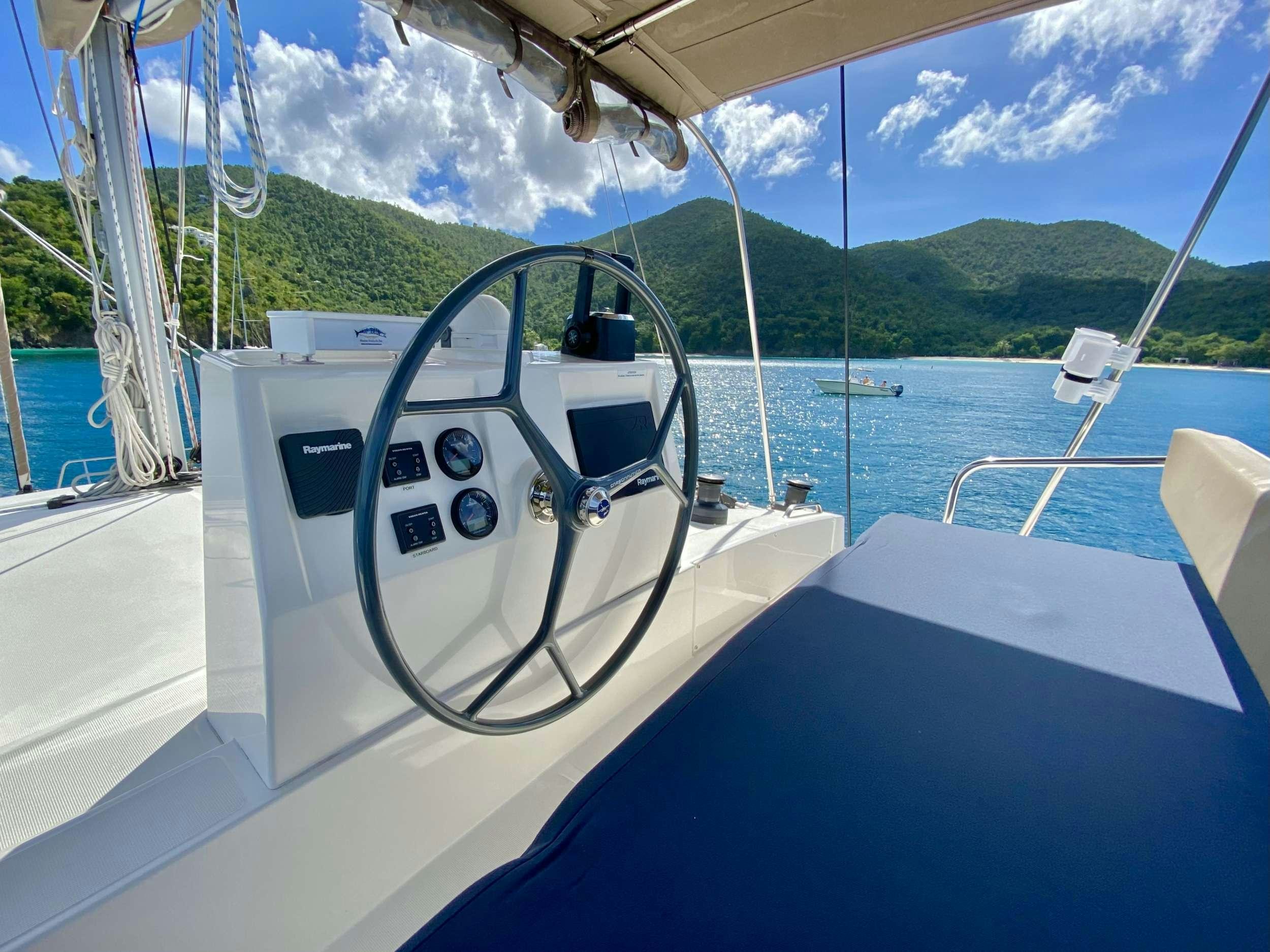 a boat with a steering wheel aboard FREESTYLE Yacht for Charter