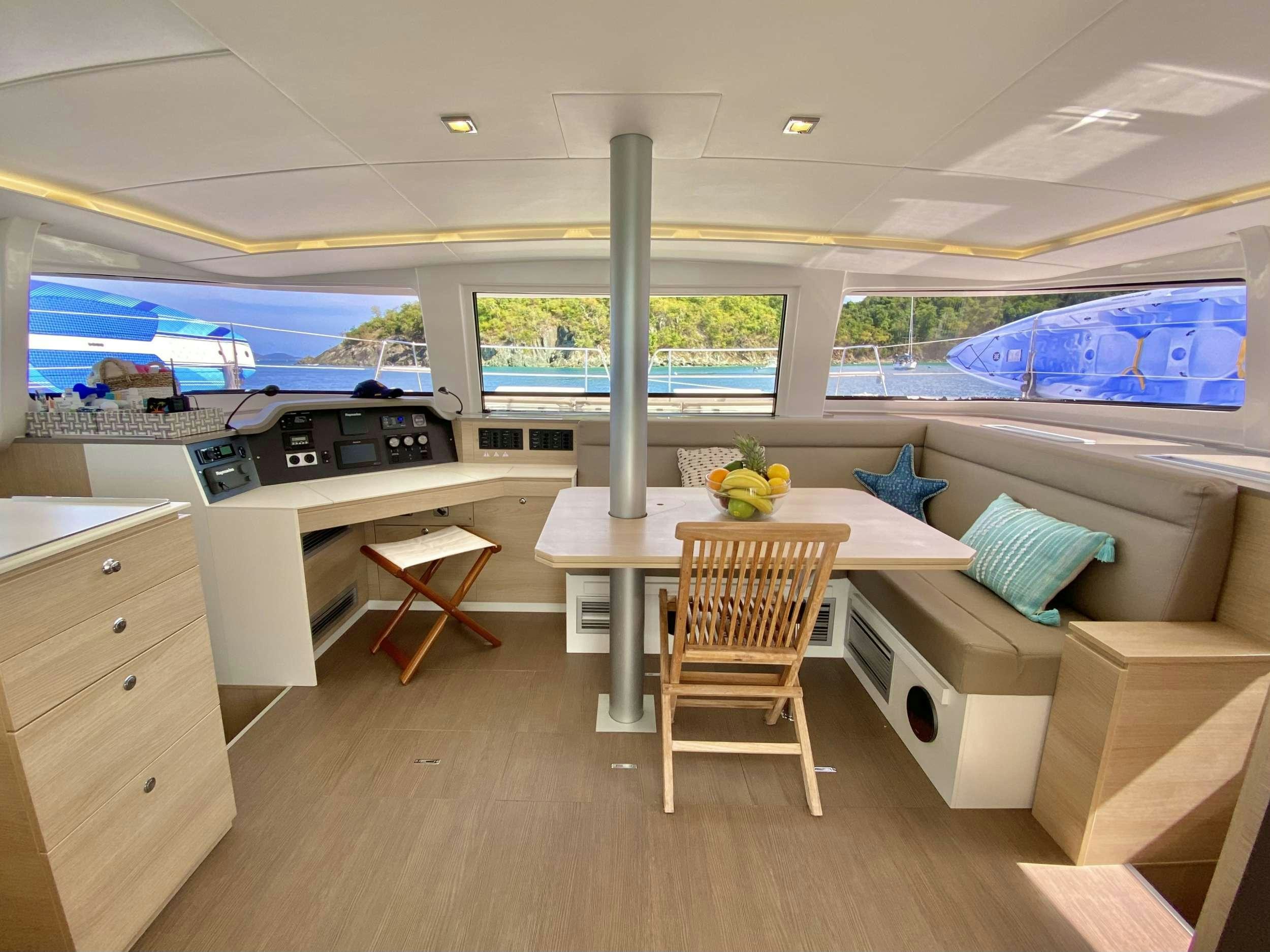 a room with a table and chairs aboard FREESTYLE Yacht for Charter