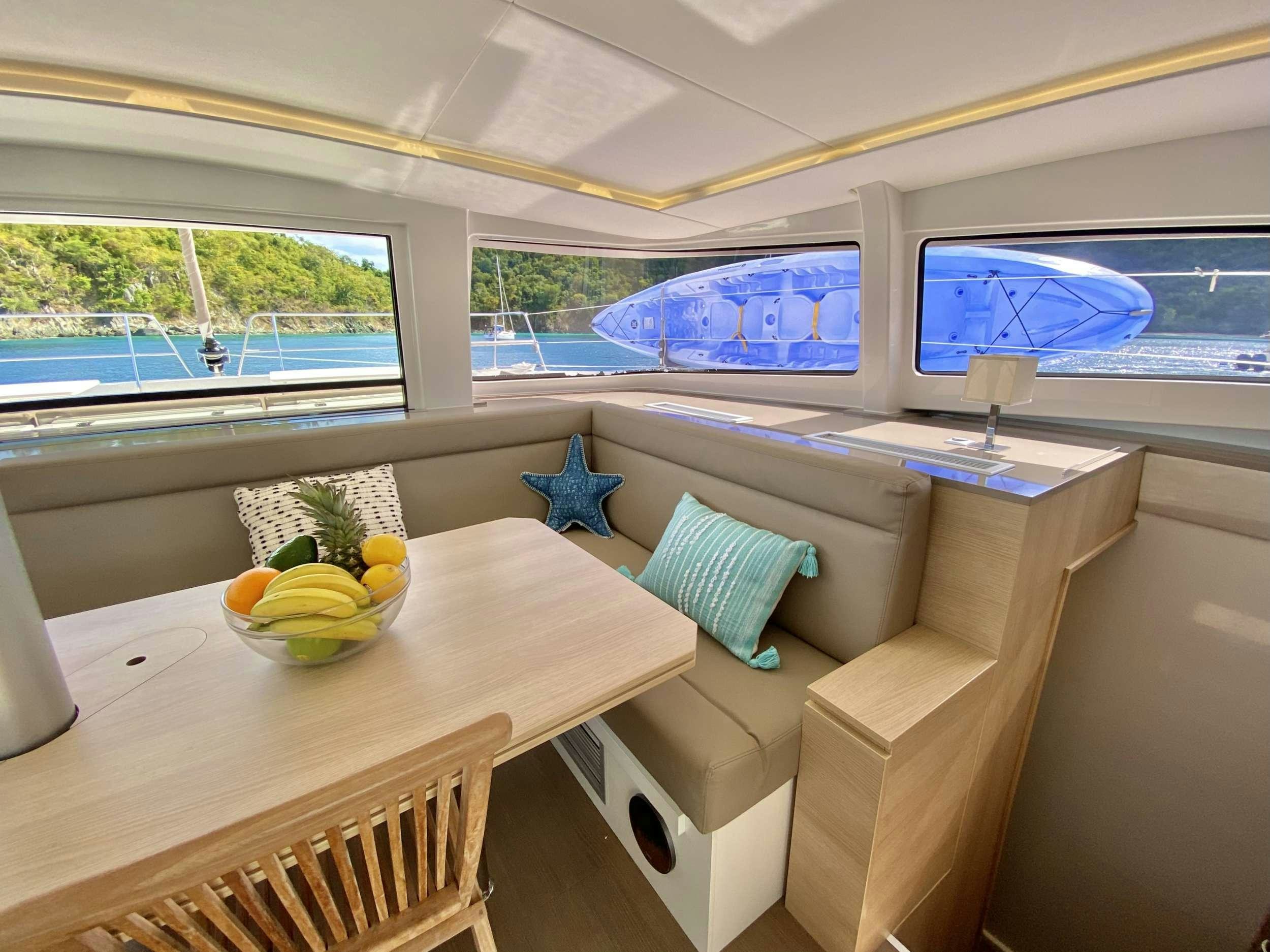 a room with a couch and a table with fruit on it aboard FREESTYLE Yacht for Charter