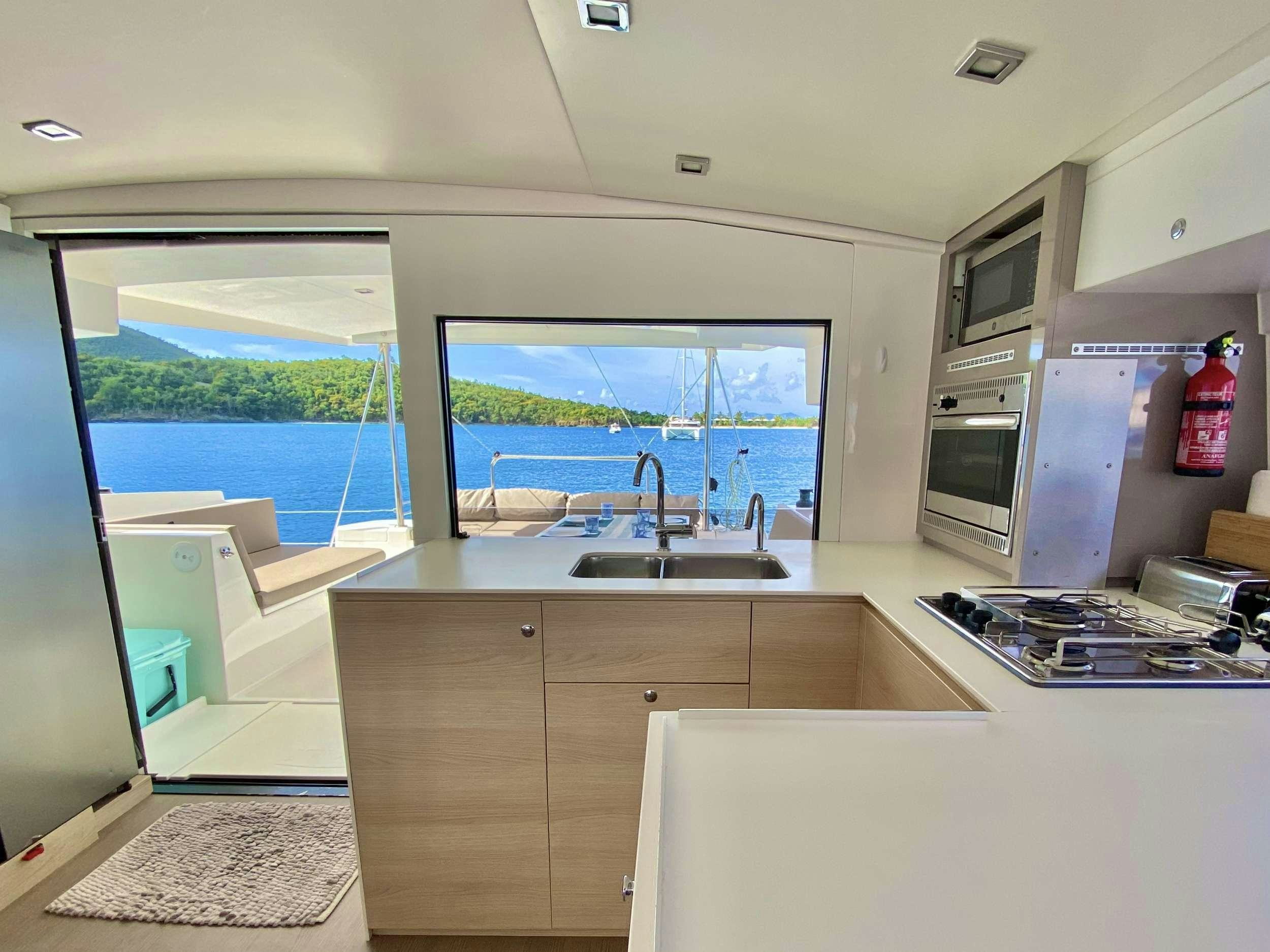 a kitchen with a large window aboard FREESTYLE Yacht for Charter