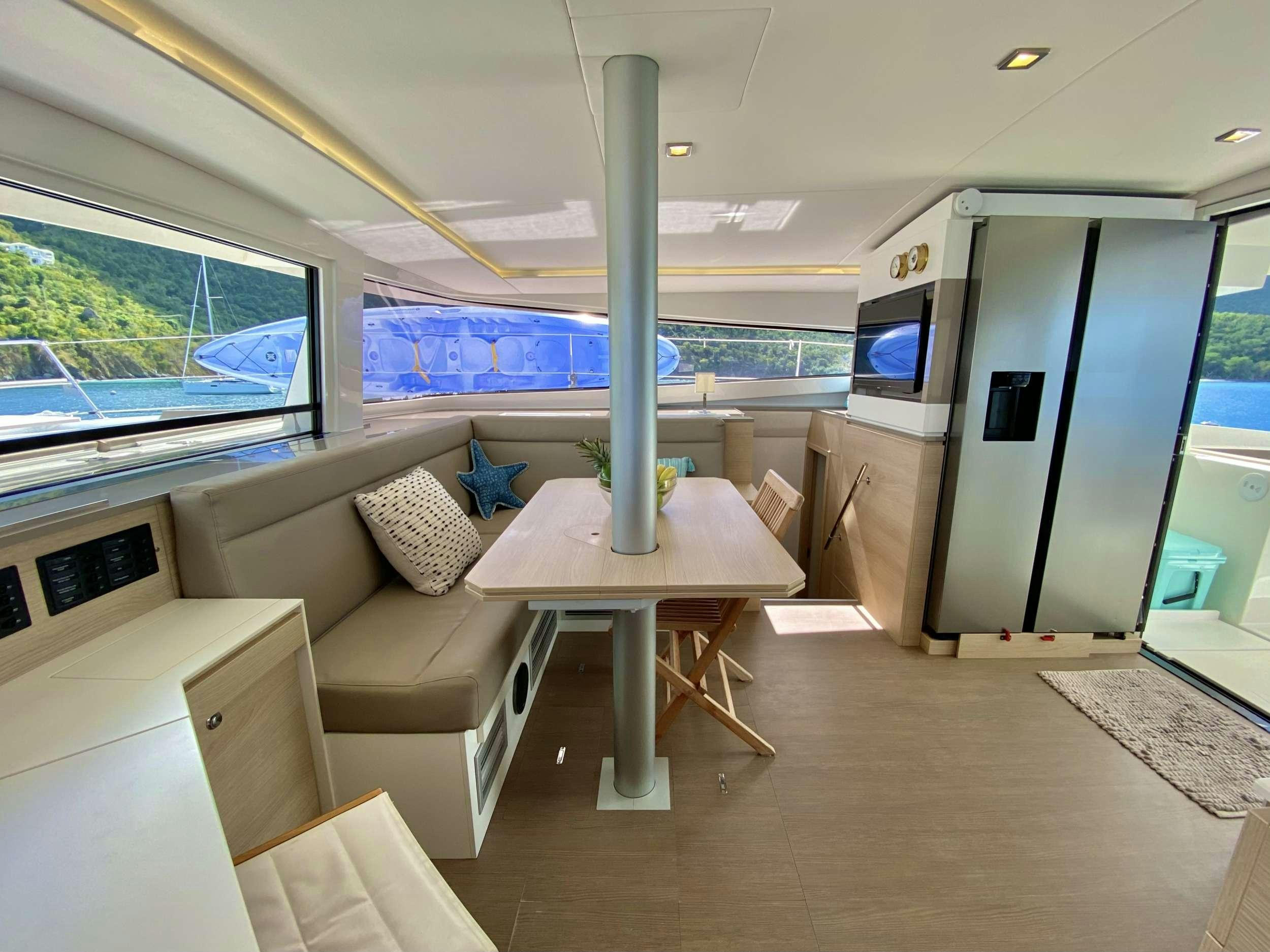 a room with a couch and a table and a tv aboard FREESTYLE Yacht for Charter