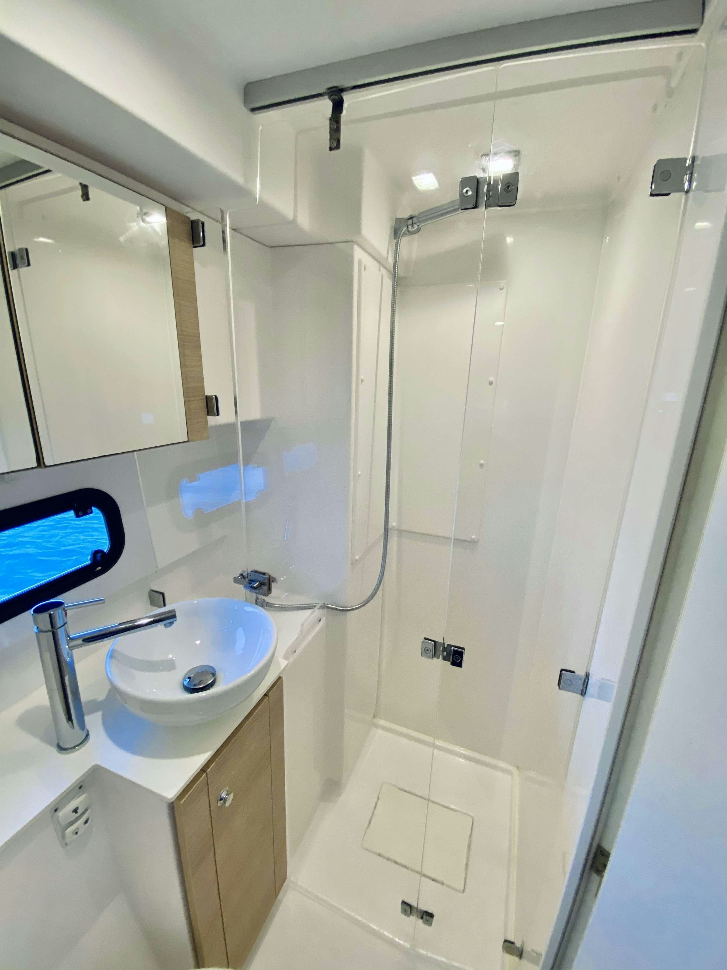 a bathroom with a sink and a mirror aboard FREESTYLE Yacht for Charter