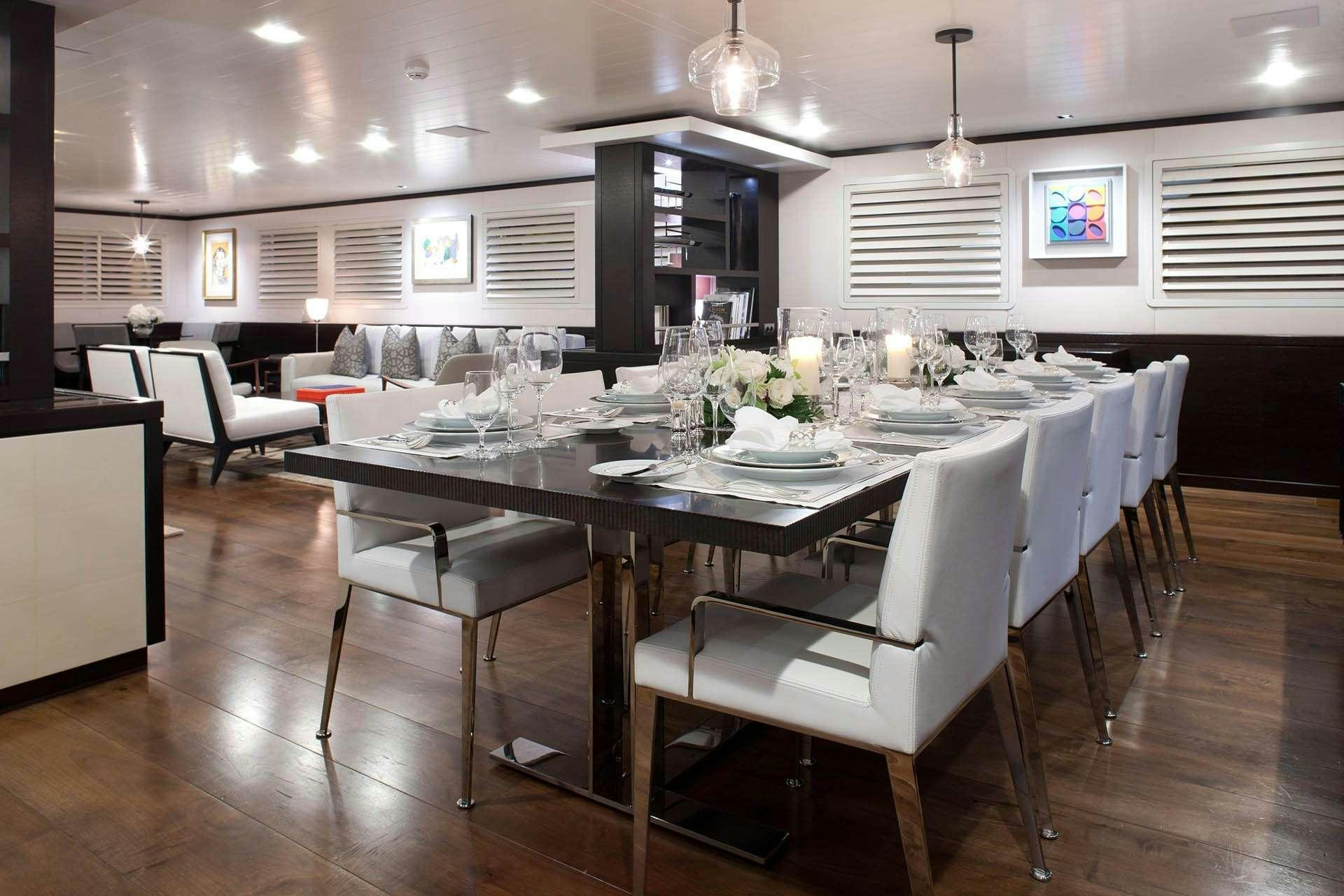 a large kitchen with a table and chairs aboard MIRAGE Yacht for Charter