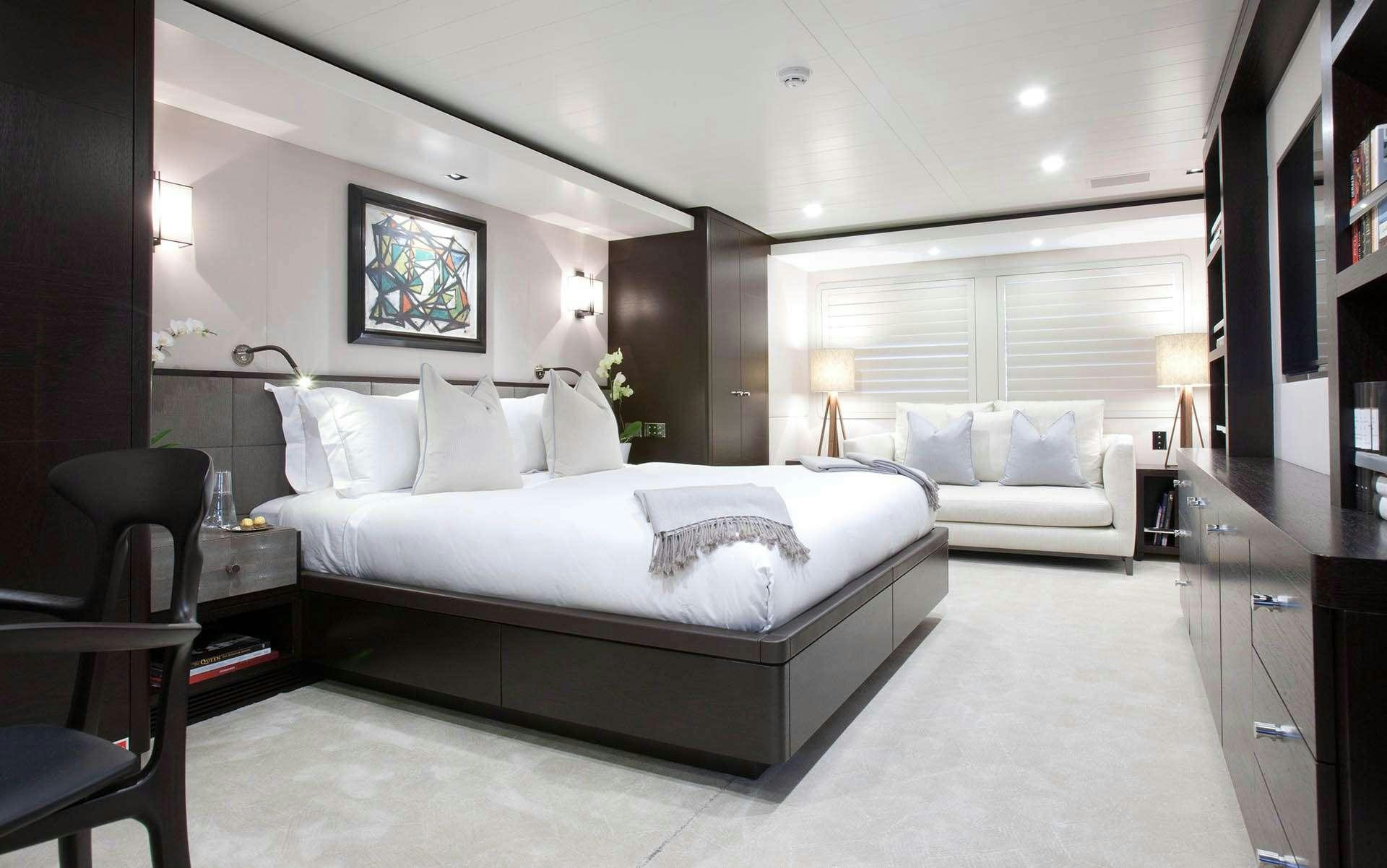 a large bedroom with a bed and a couch aboard MIRAGE Yacht for Charter