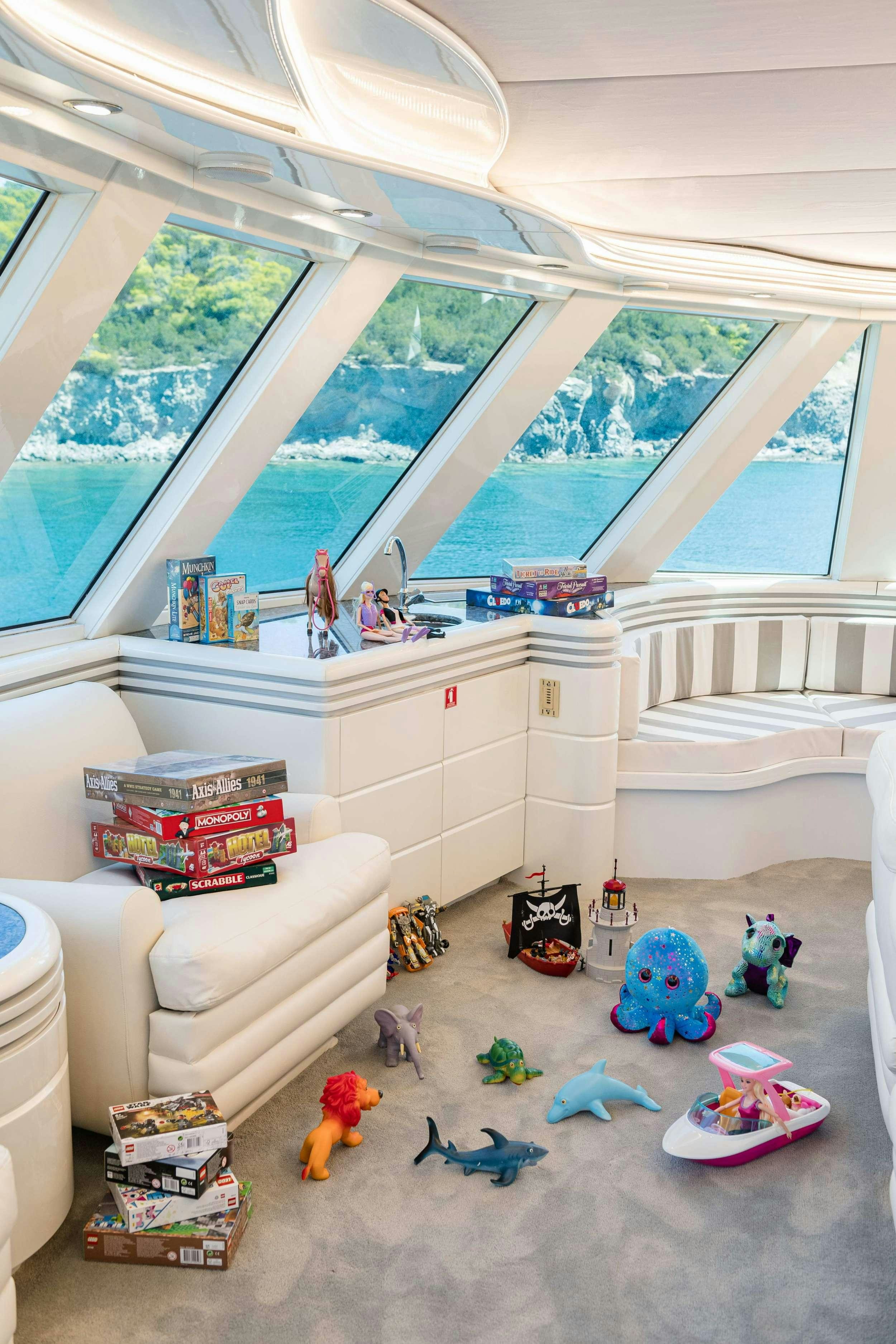 a room with a couch and toys aboard WIND OF FORTUNE Yacht for Charter
