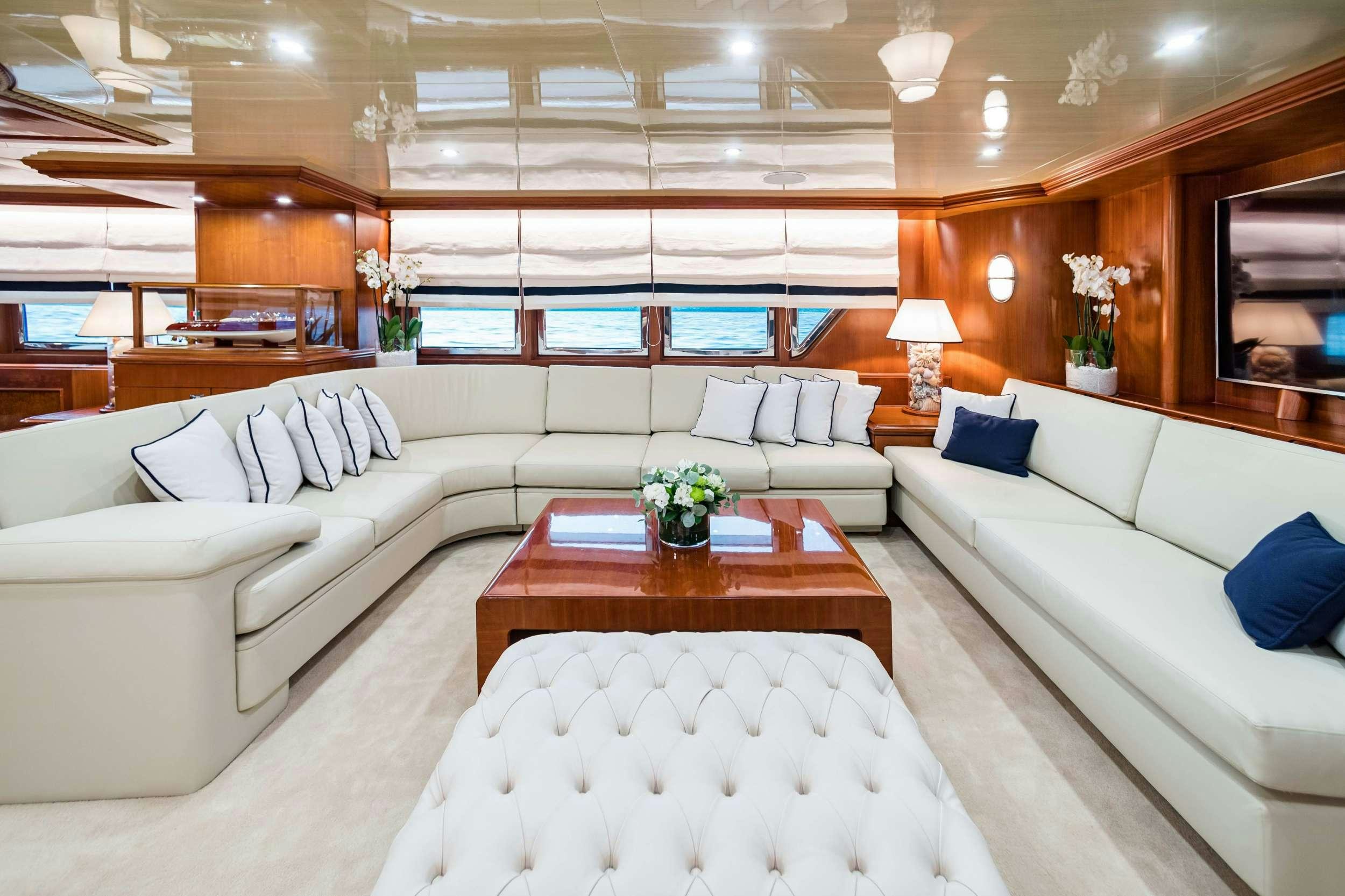 a living room with a couch and a table aboard WIND OF FORTUNE Yacht for Charter