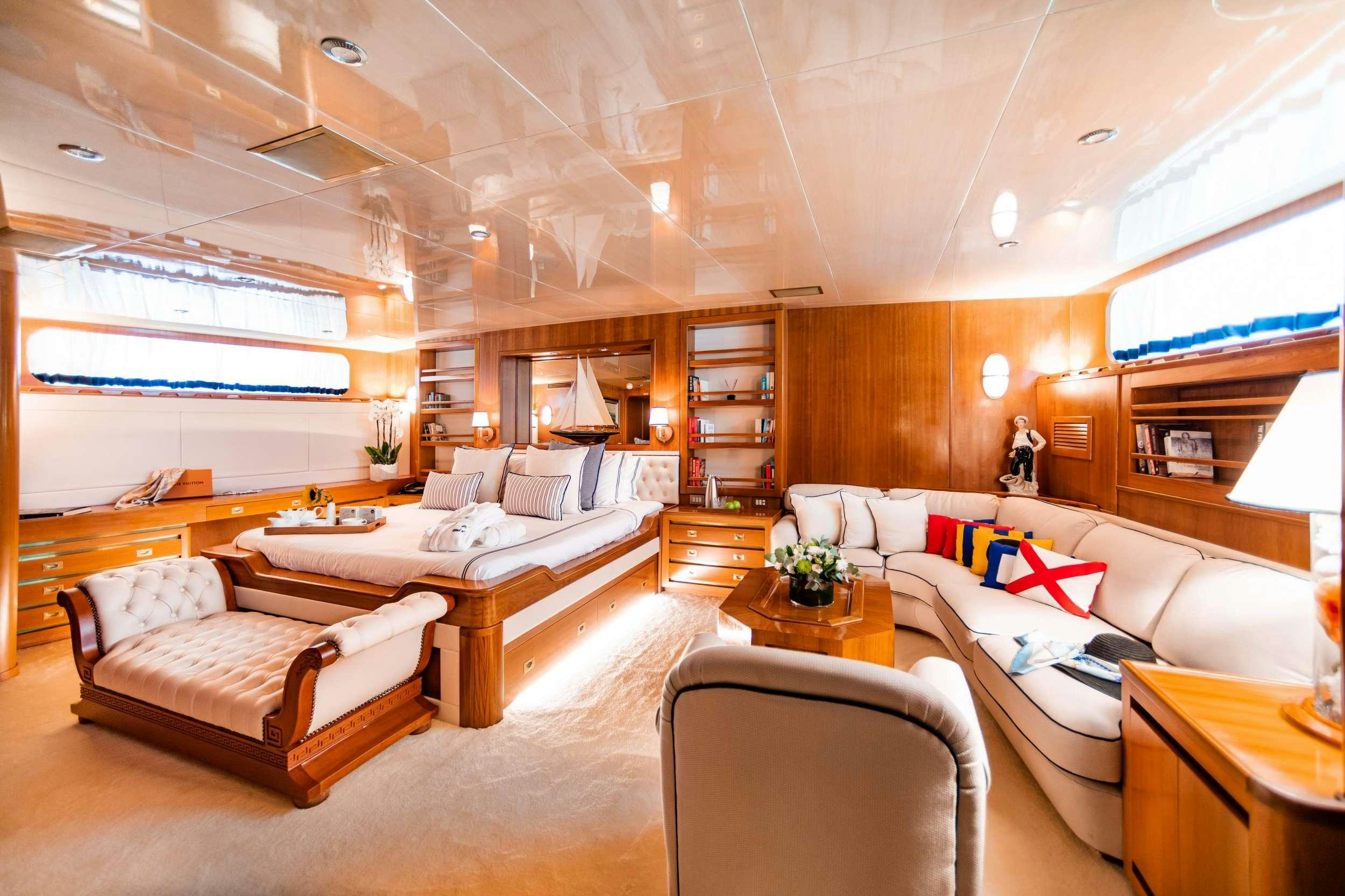 a living room with a couch and a table aboard WIND OF FORTUNE Yacht for Charter