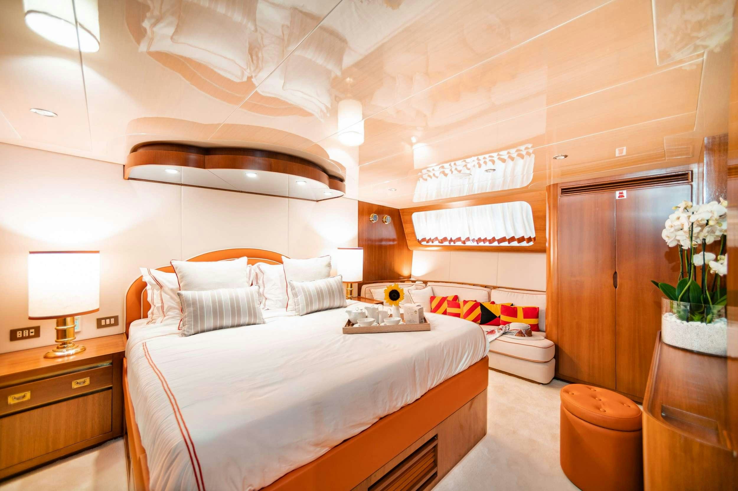 a bedroom with a bed and a desk aboard WIND OF FORTUNE Yacht for Charter