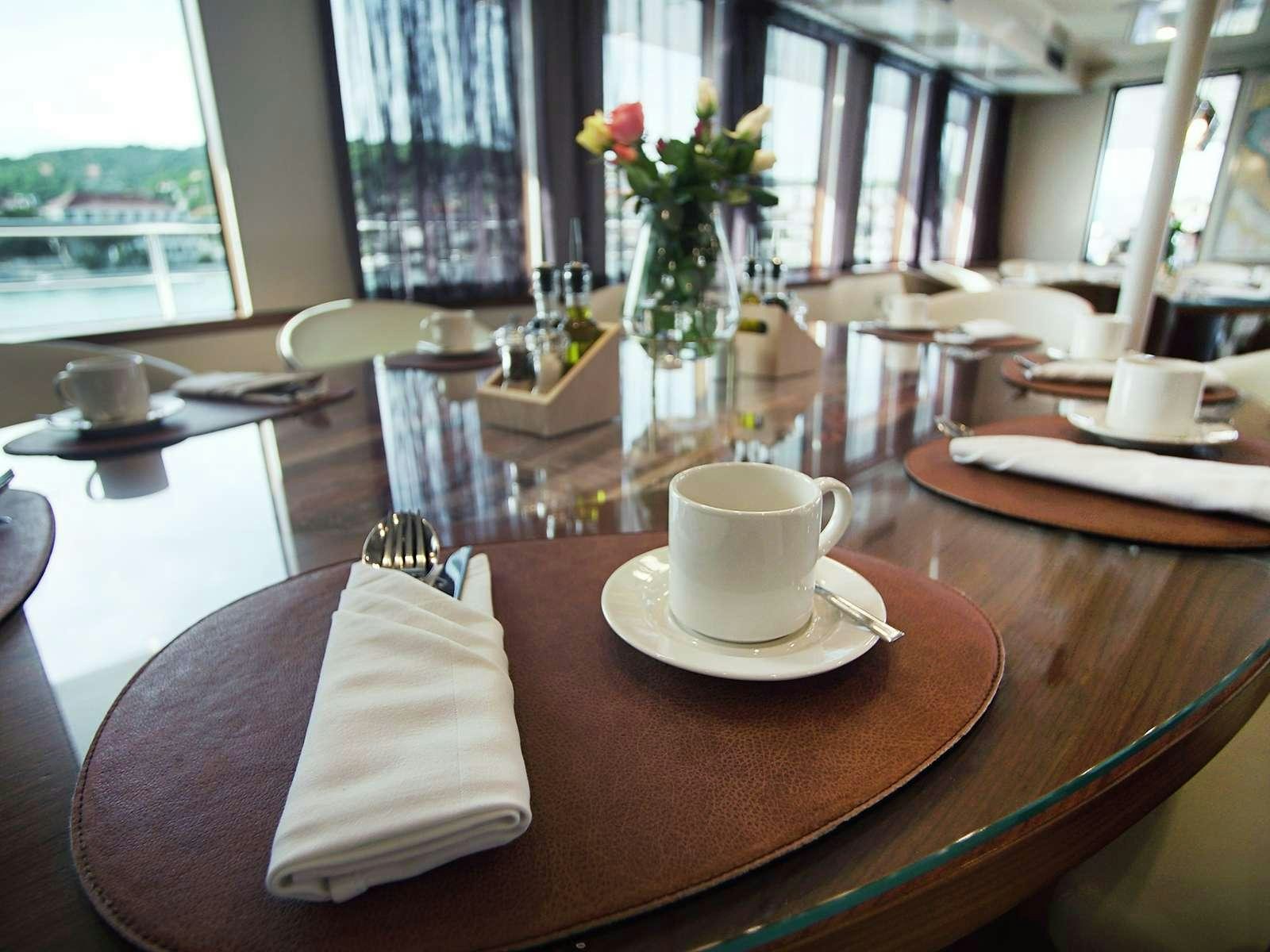 a table with a vase of flowers aboard YOLO Yacht for Charter