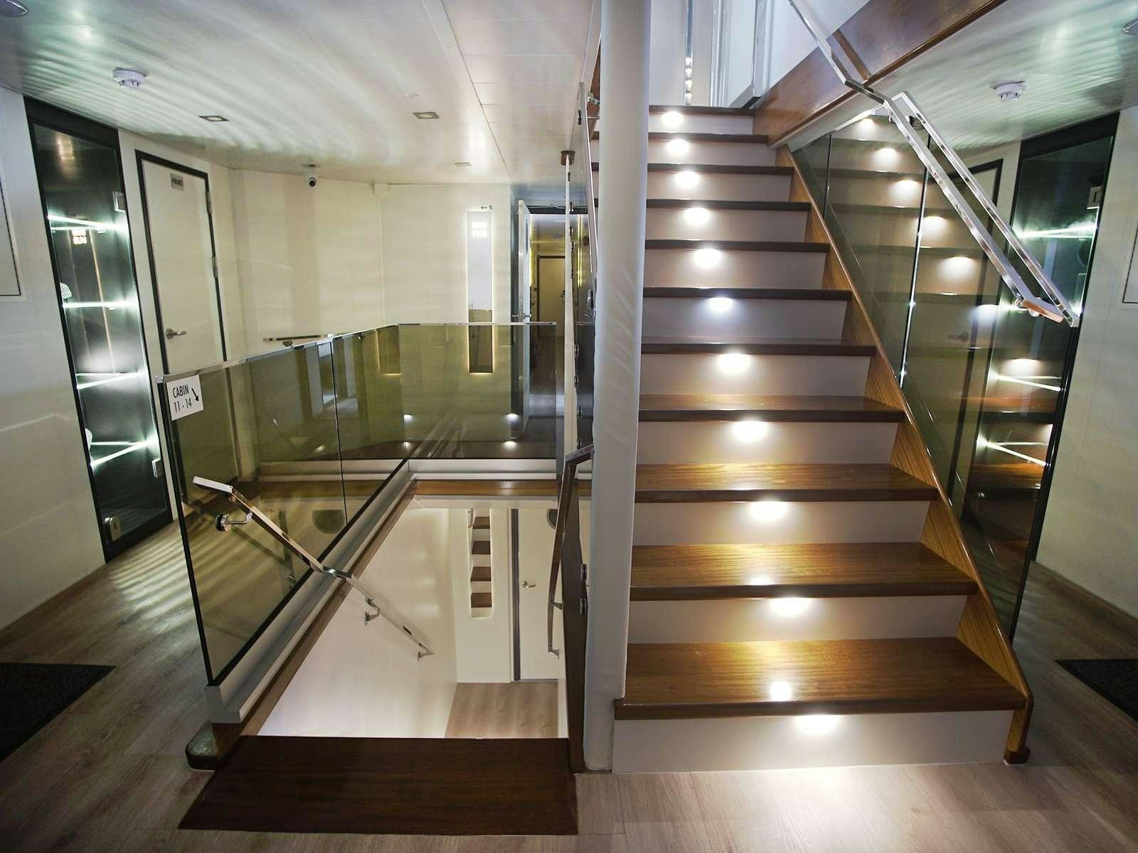 a wooden staircase in a building aboard YOLO Yacht for Charter