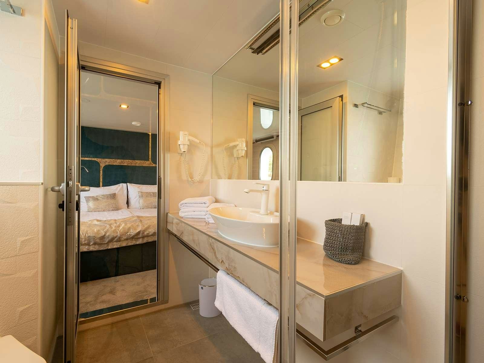 a bathroom with a large mirror aboard YOLO Yacht for Charter