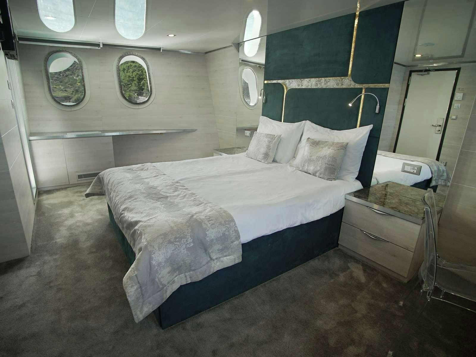 a room with two beds aboard YOLO Yacht for Charter