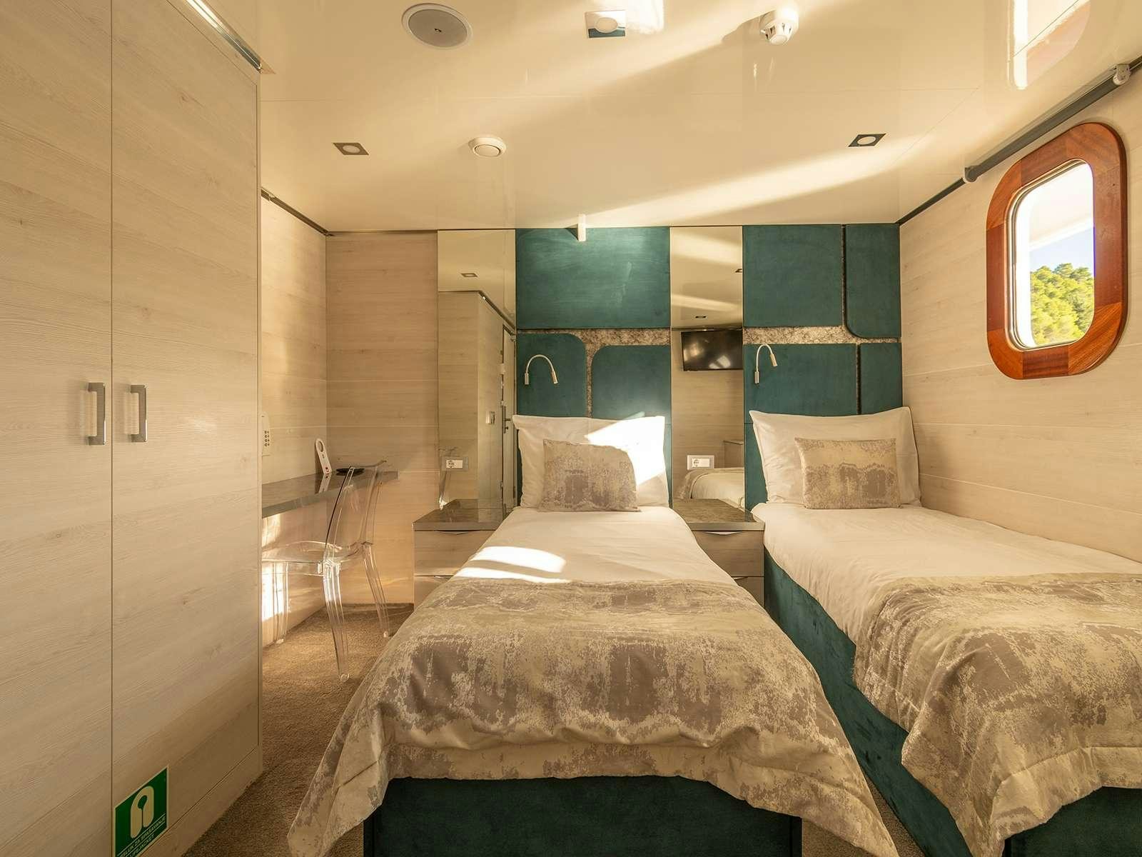 a room with two beds aboard YOLO Yacht for Charter