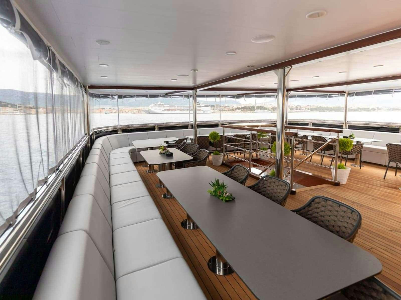 a room with a table and chairs aboard FREEDOM Yacht for Charter
