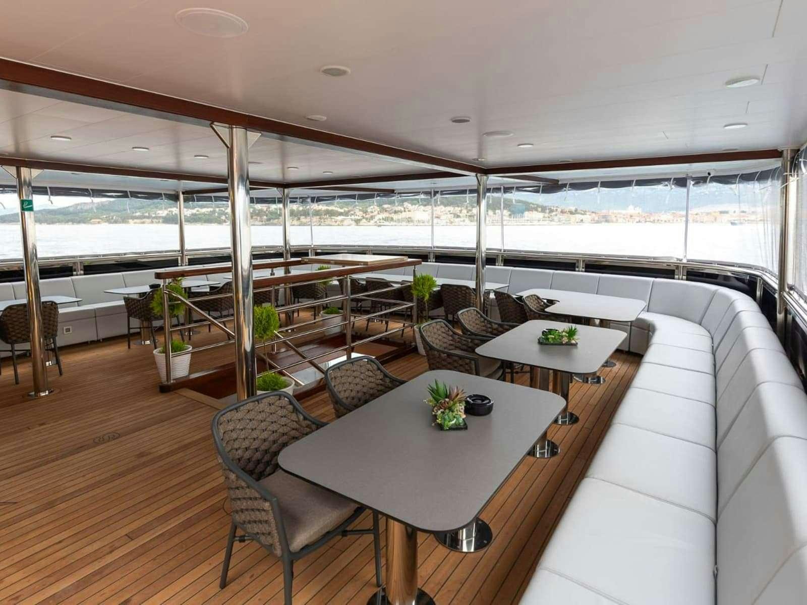 a room with a table and chairs aboard FREEDOM Yacht for Charter