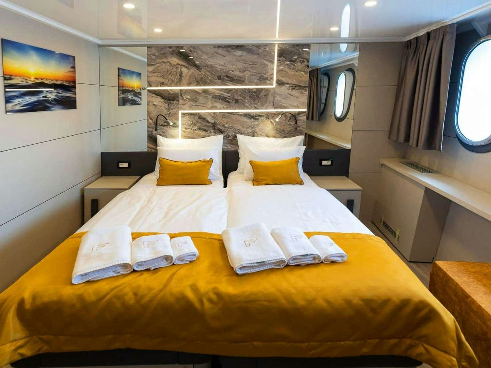 a hotel room with a bed aboard FREEDOM Yacht for Charter