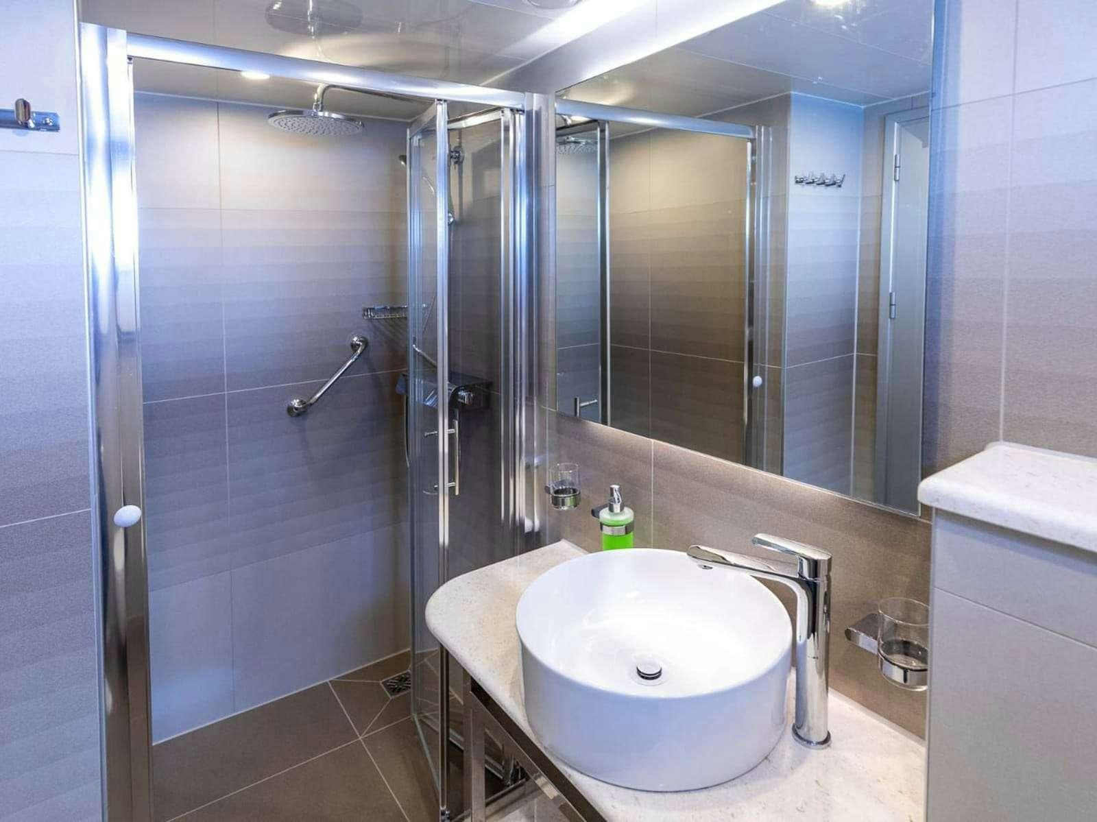a bathroom with a sink and a shower aboard FREEDOM Yacht for Charter