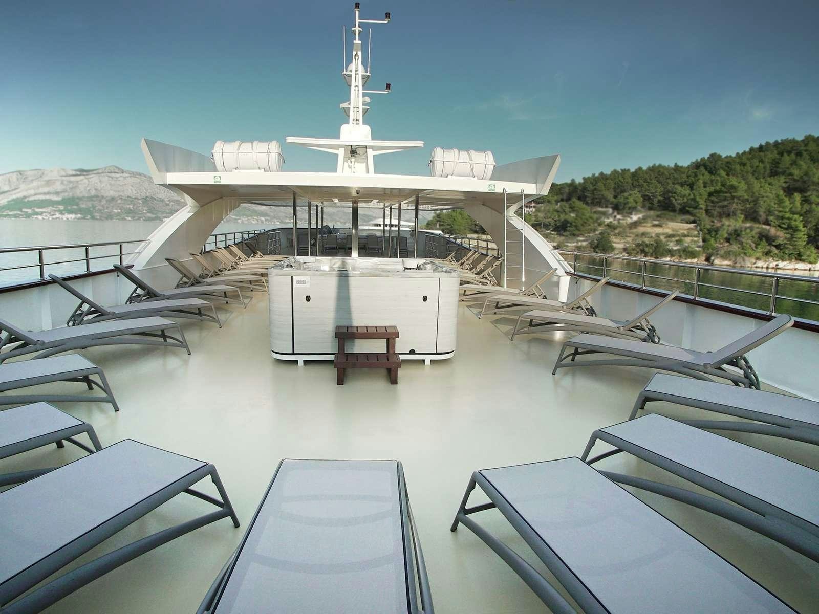 a deck with a large white building and a tower on it aboard OHANA Yacht for Charter