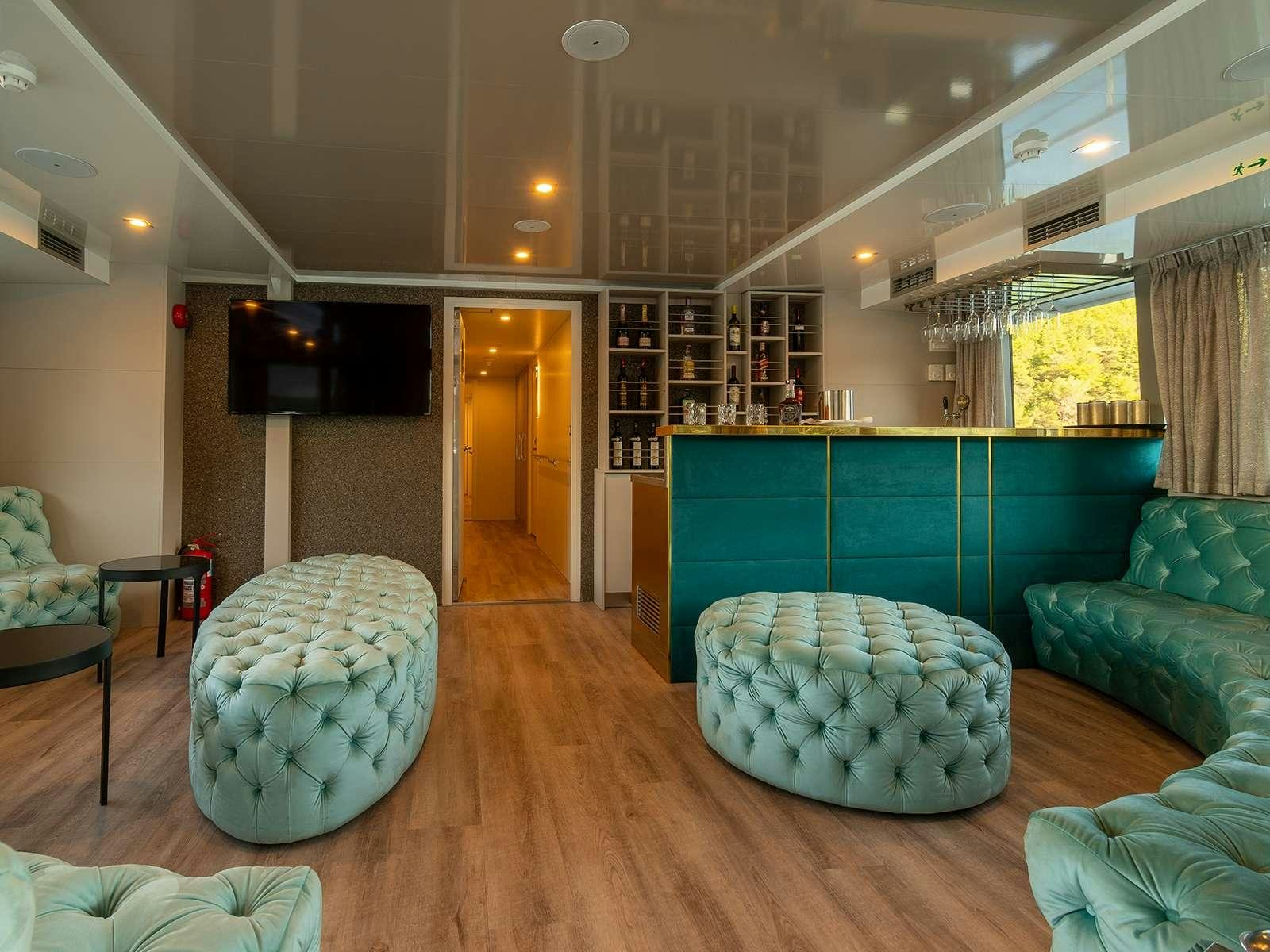 a room with couches and a television aboard OHANA Yacht for Charter