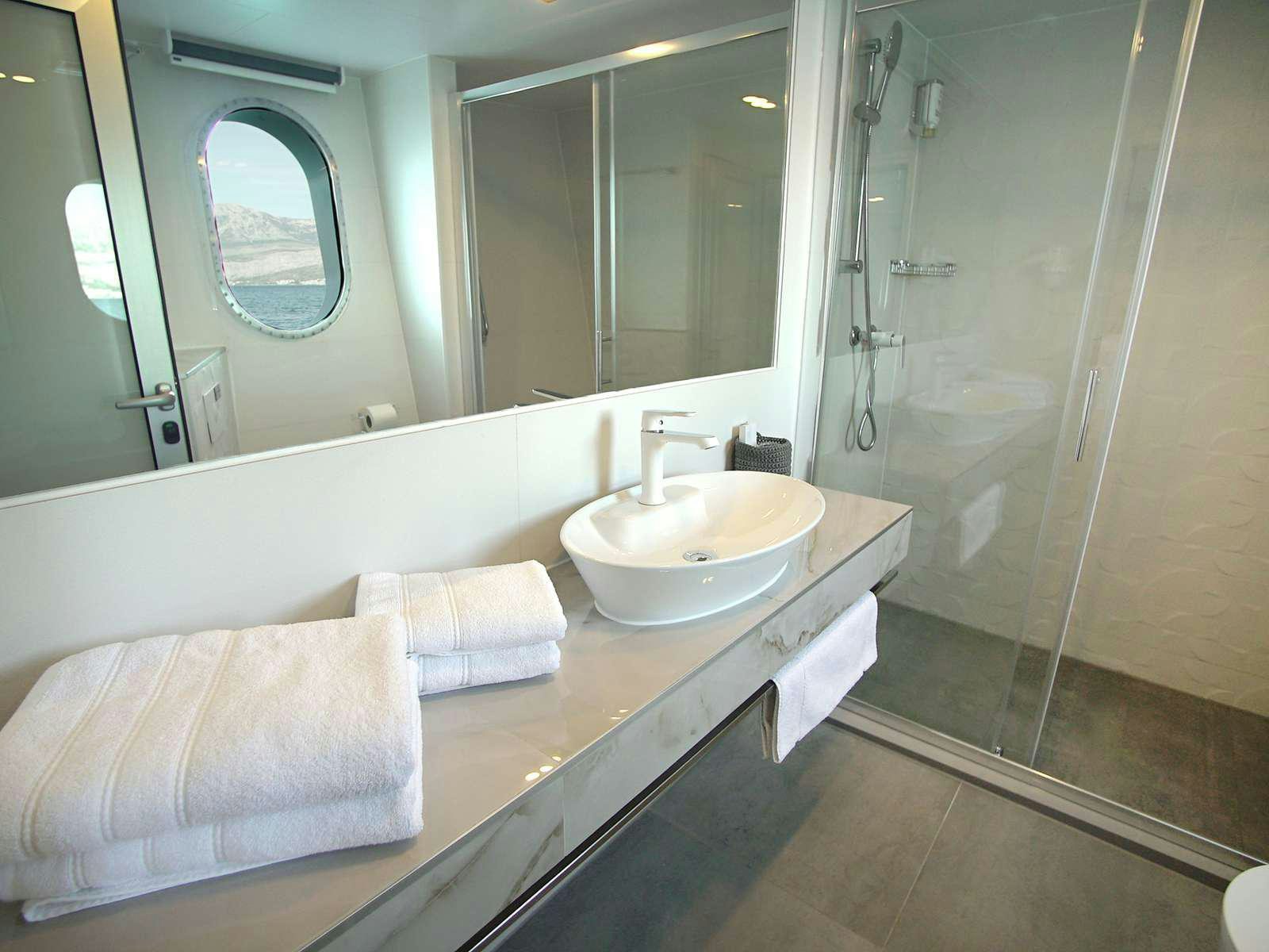a bathroom with a sink and a mirror aboard OHANA Yacht for Charter