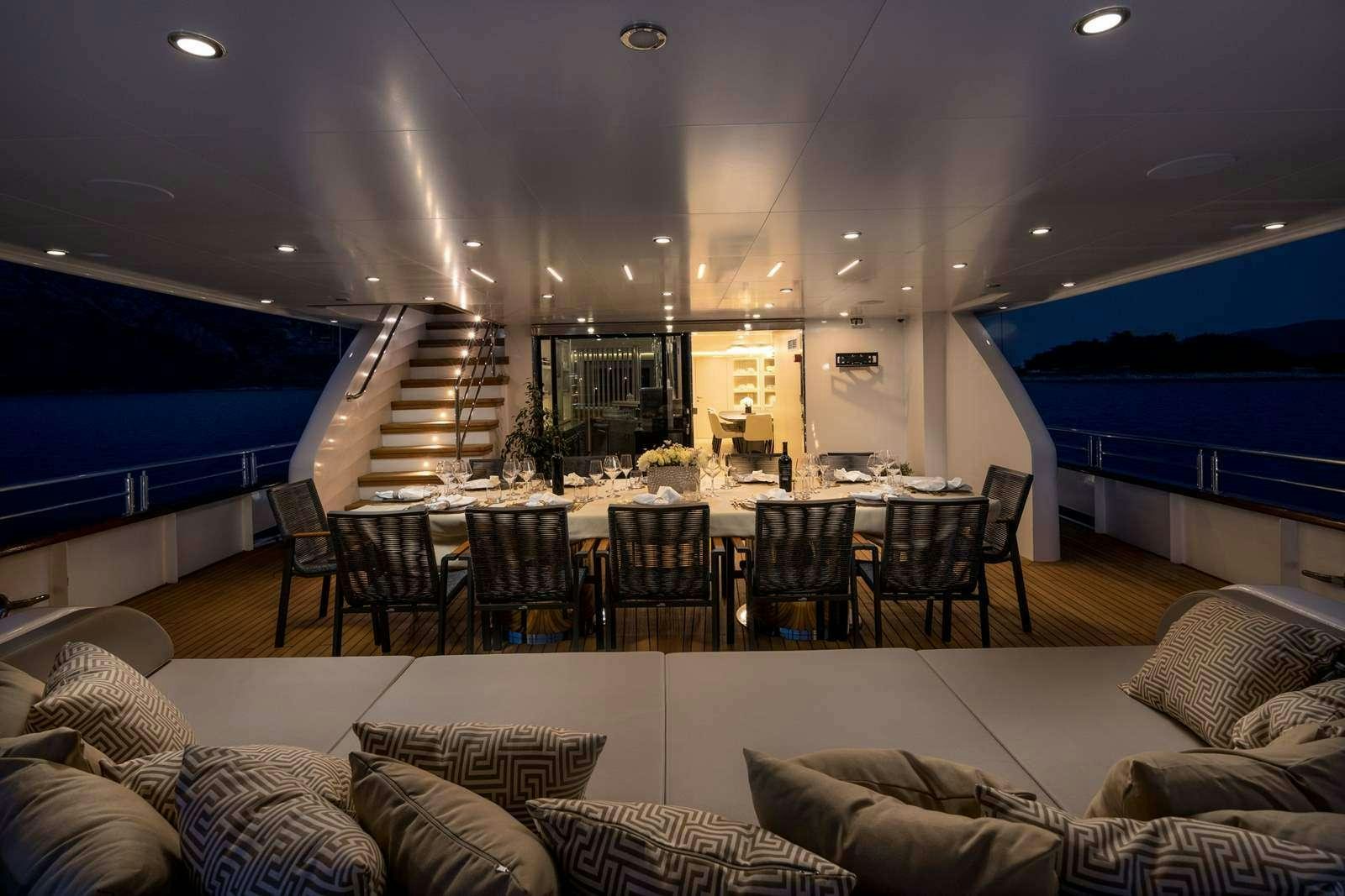 a living room with a large table and chairs aboard LOVE STORY Yacht for Charter