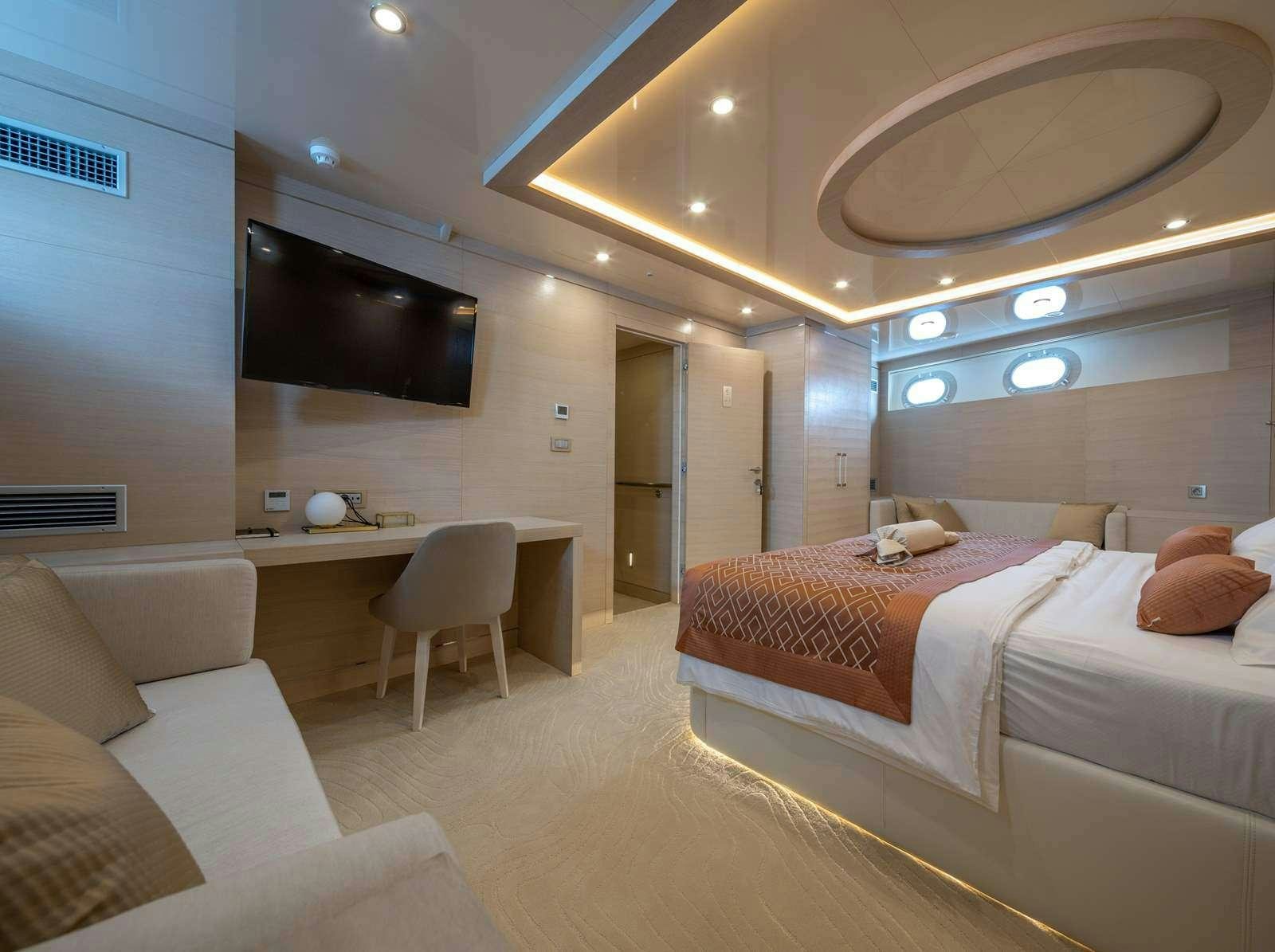 a room with a bed and a tv aboard LOVE STORY Yacht for Charter
