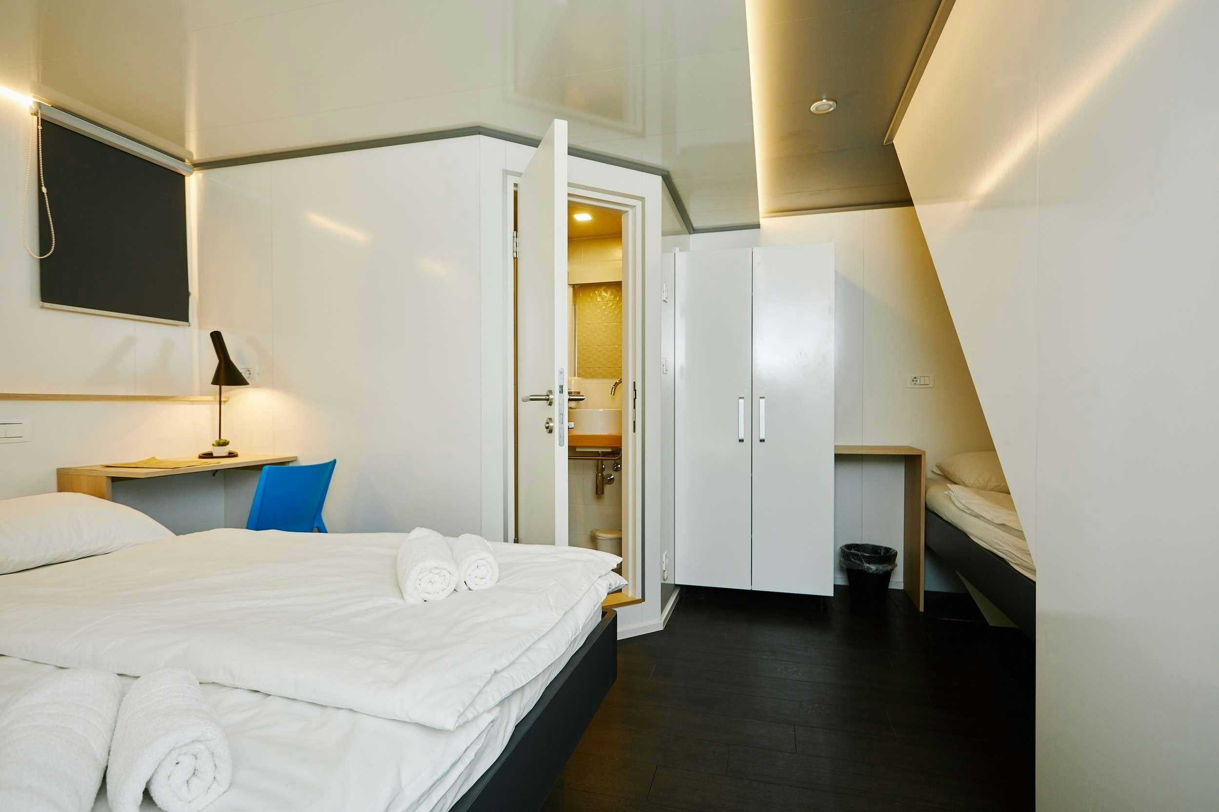 a room with a bed and a mirror aboard ALMISSA Yacht for Charter