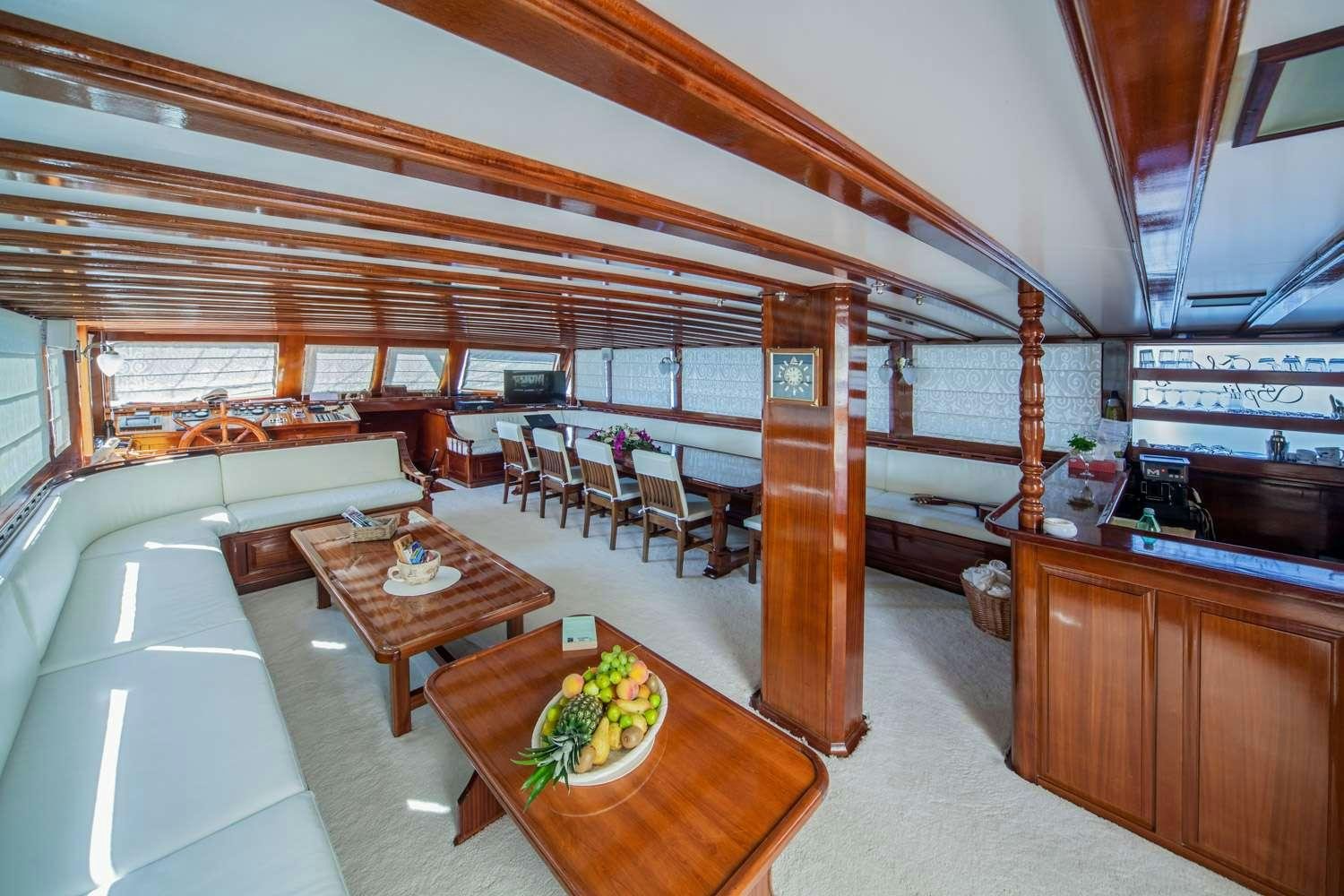 a room with a table and chairs aboard STELLA MARIS Yacht for Charter