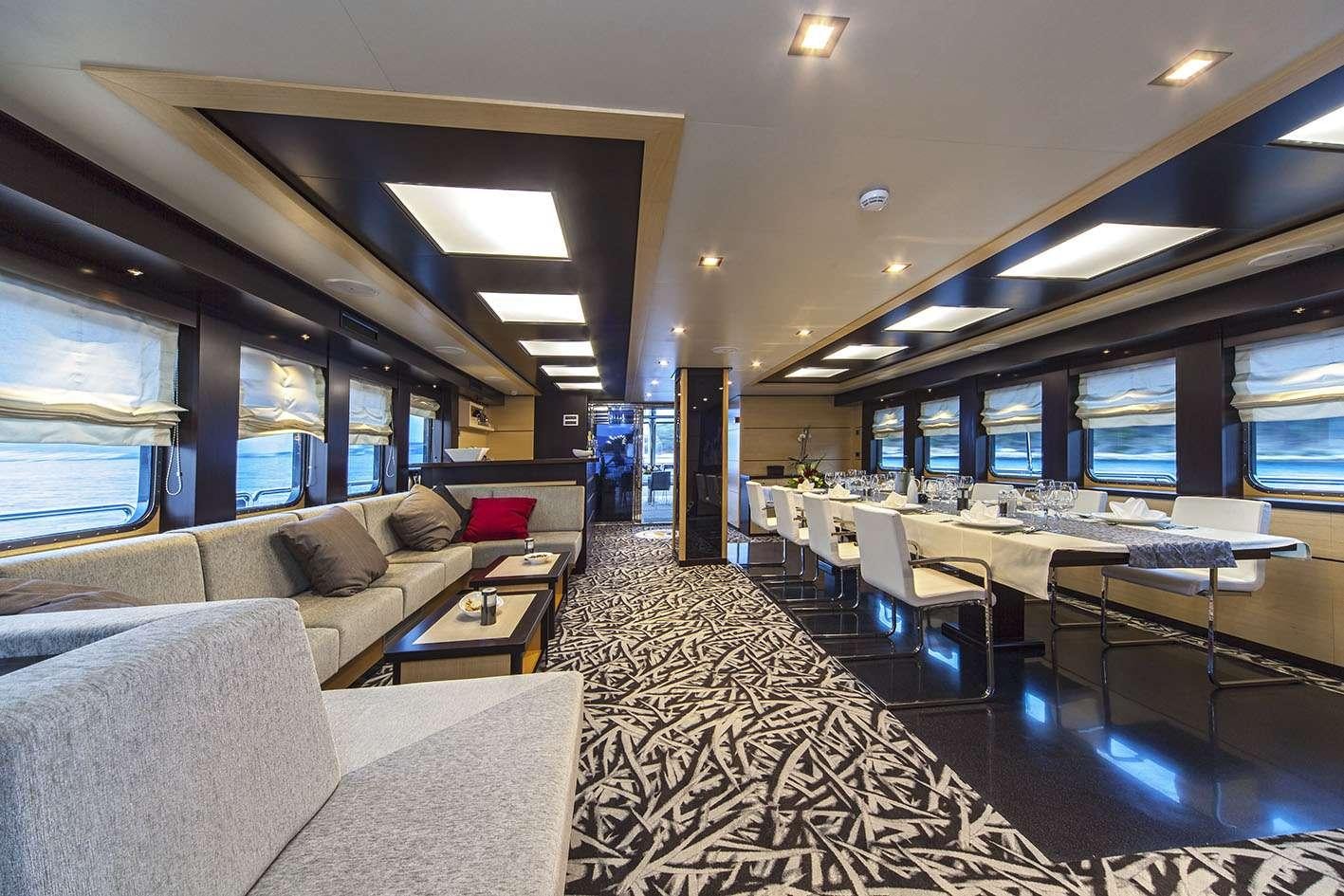 a large room with a couch and a tv aboard NAVILUX Yacht for Charter