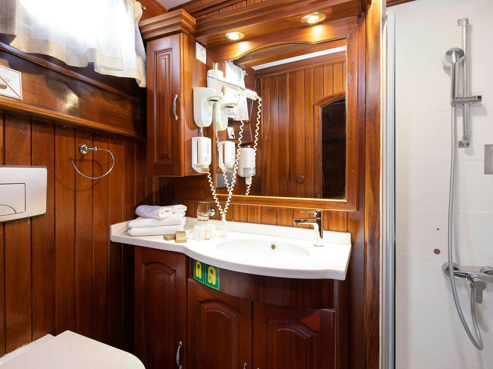 a bathroom with a sink and a shower aboard GULET NOSTRA VITA Yacht for Charter