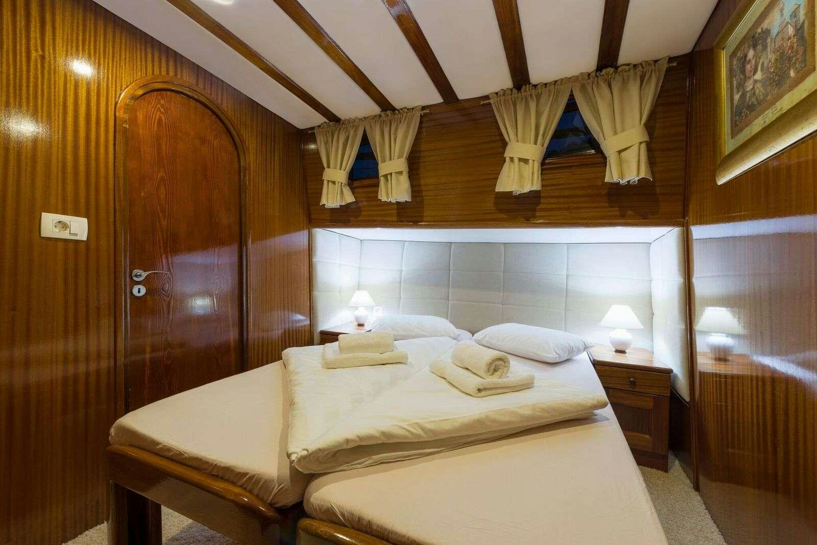 a bed with a canopy over it aboard LINDA Yacht for Charter