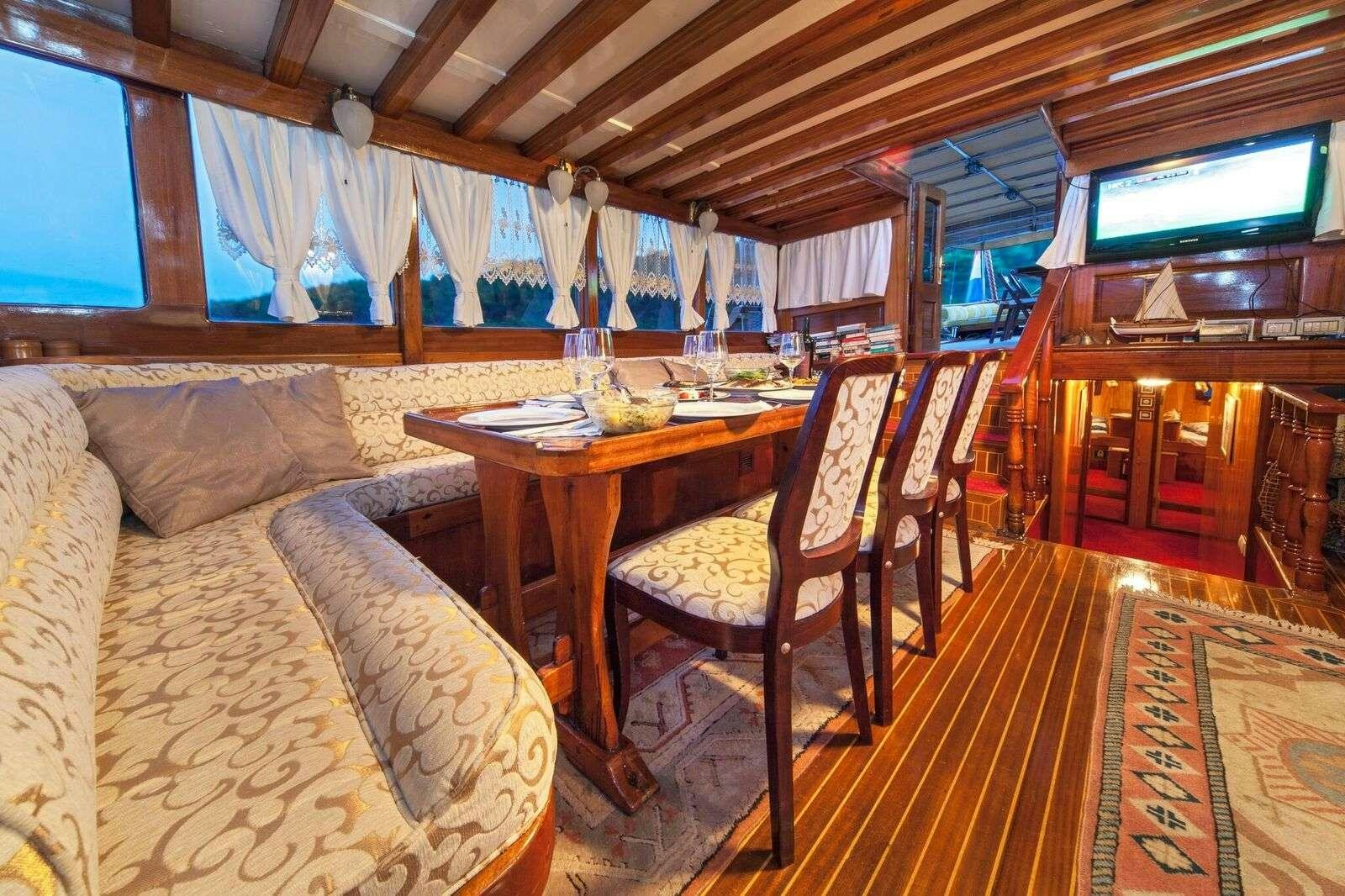 a room with a couch and a table aboard LINDA Yacht for Charter