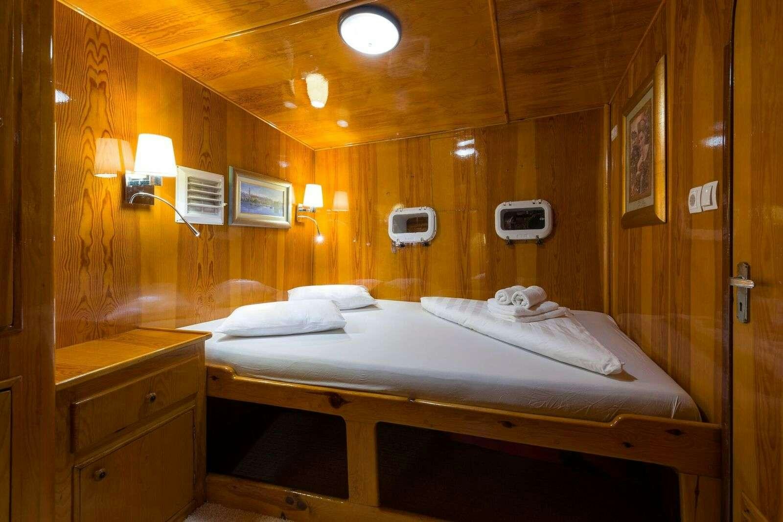 a hotel room with a bed aboard LINDA Yacht for Charter