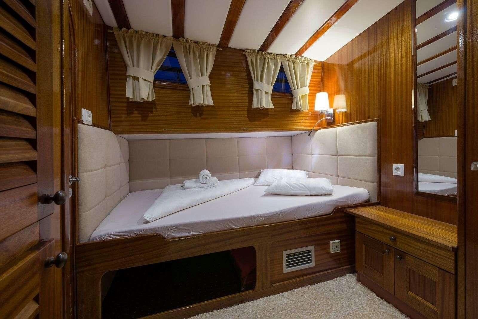 a bed in a room aboard LINDA Yacht for Charter