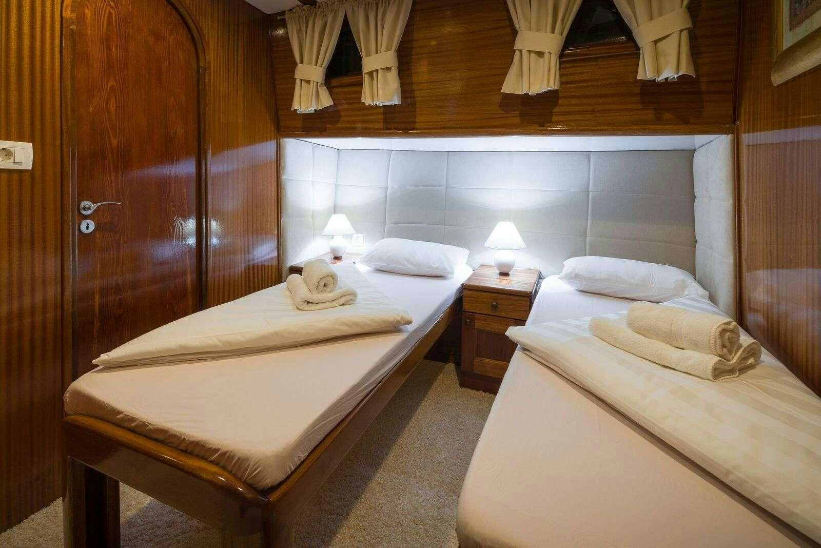 a couple of beds in a hotel room aboard LINDA Yacht for Charter