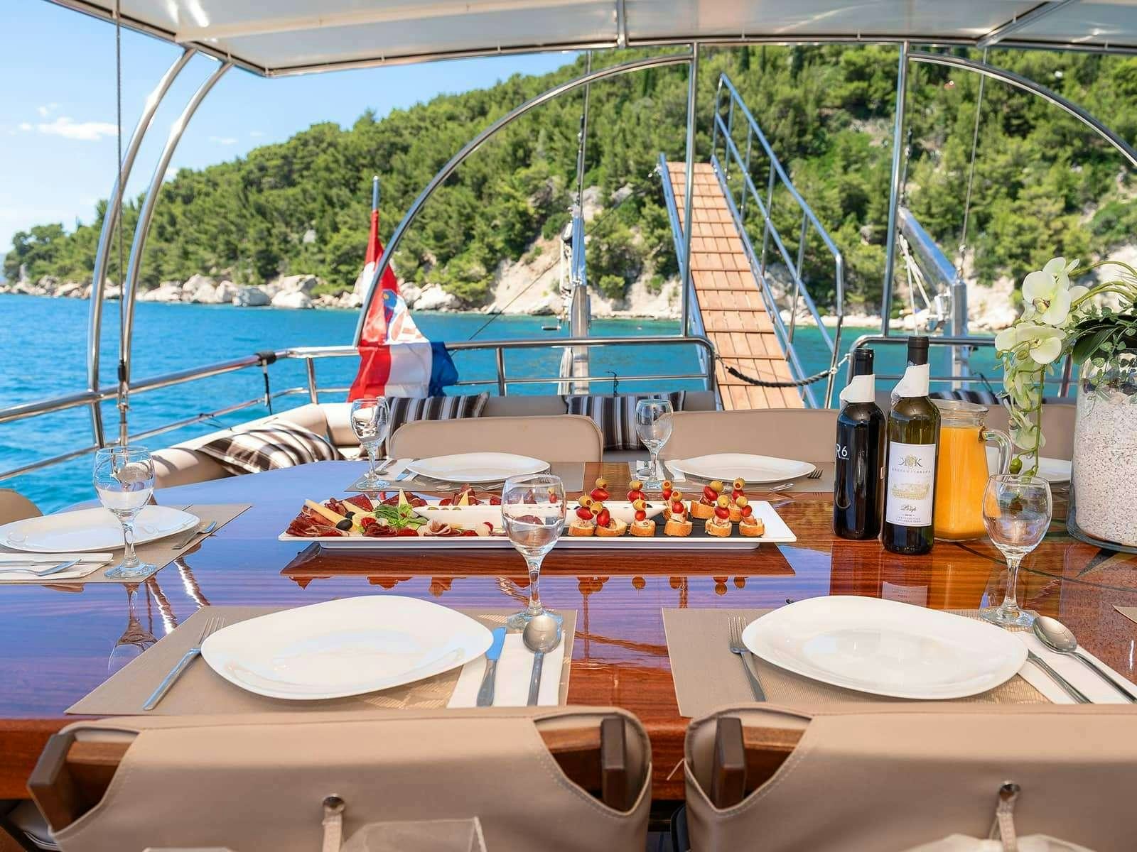 a table set for a dinner party aboard Gulet Nautilus Yacht for Charter