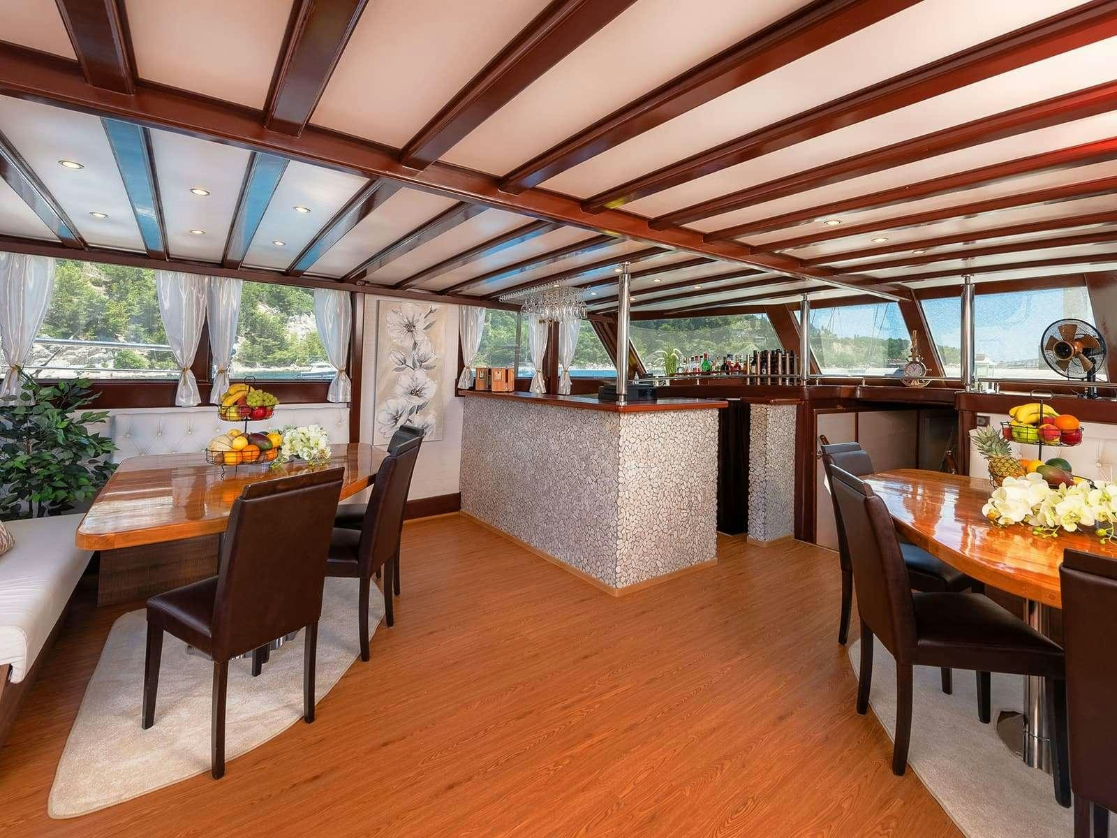 a room with a table and chairs aboard Gulet Nautilus Yacht for Charter