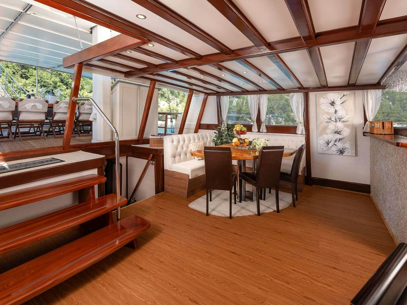 a room with a table and chairs aboard Gulet Nautilus Yacht for Charter