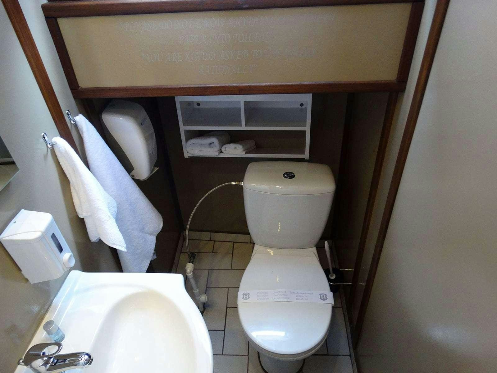 a bathroom with a toilet and sink aboard Gulet Nautilus Yacht for Charter