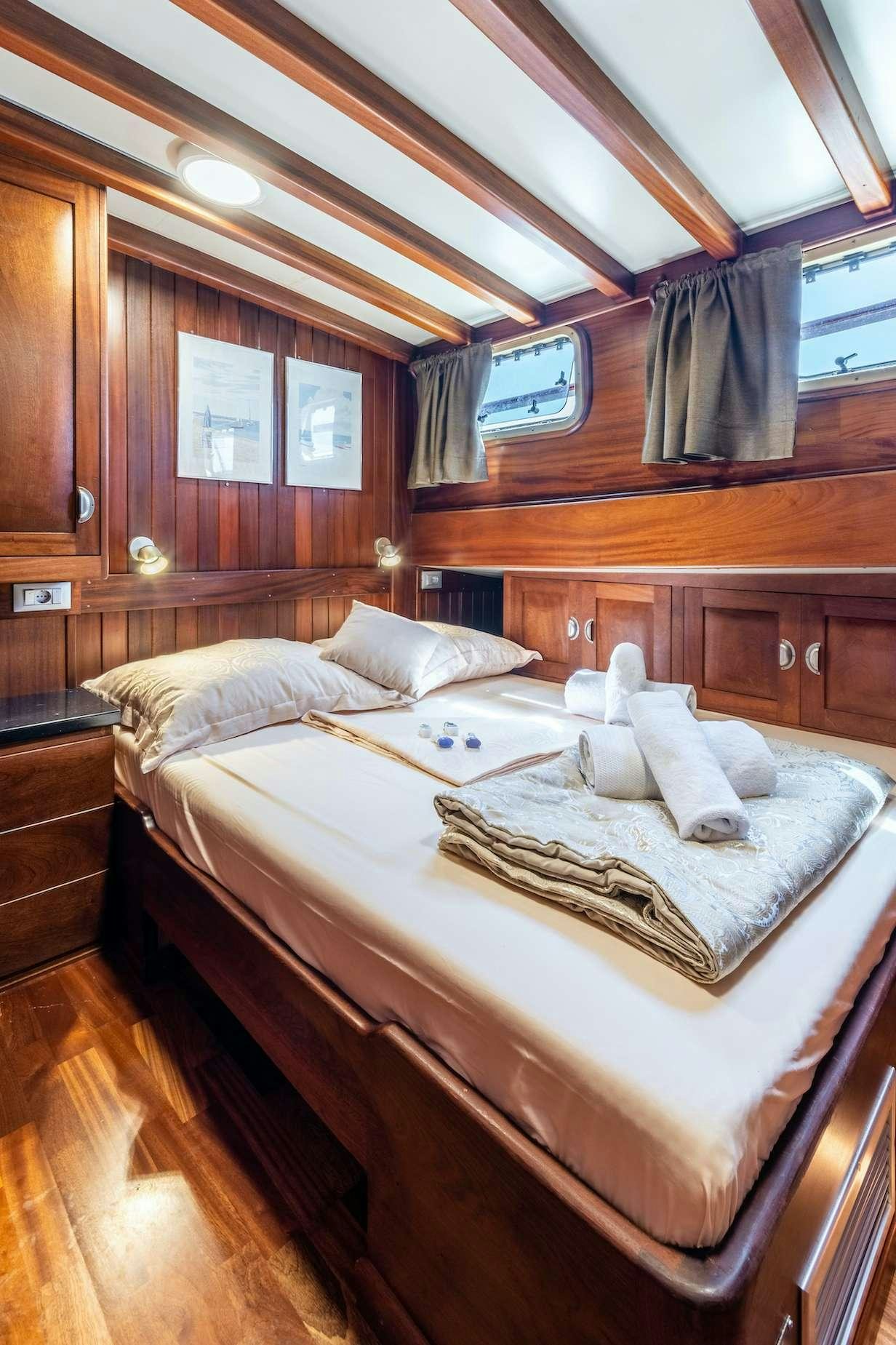 a bed with white sheets aboard ANGELICA Yacht for Charter