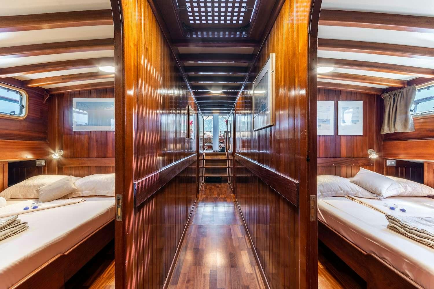a cabin with a bed and a window aboard ANGELICA Yacht for Charter