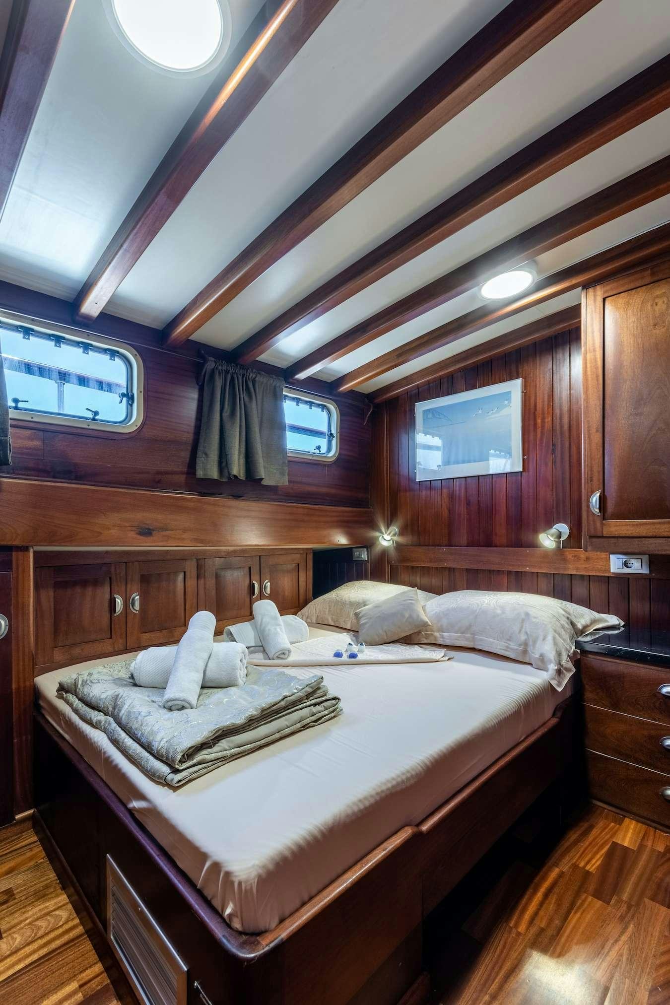a room with a bed and a window aboard ANGELICA Yacht for Charter