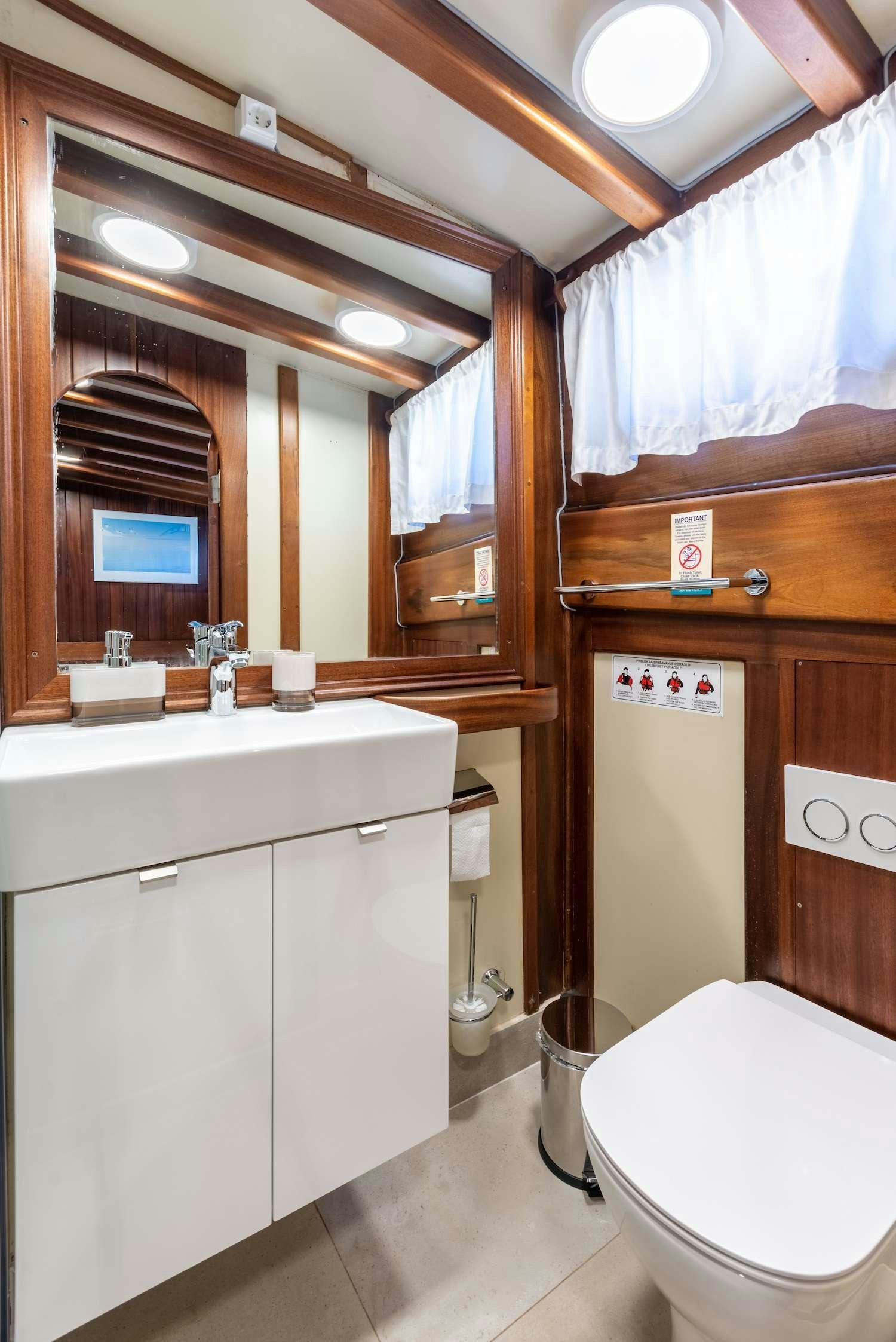 a bathroom with a toilet and sink aboard ANGELICA Yacht for Charter