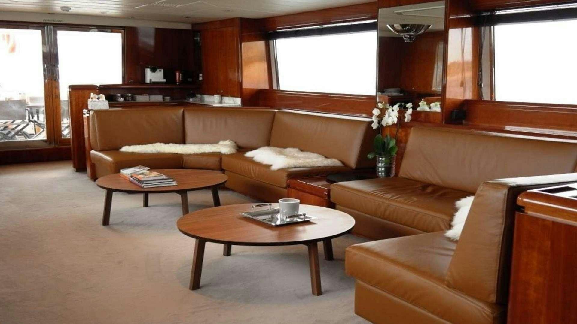 a living room with a couch and coffee table aboard MOONRAKER II Yacht for Charter