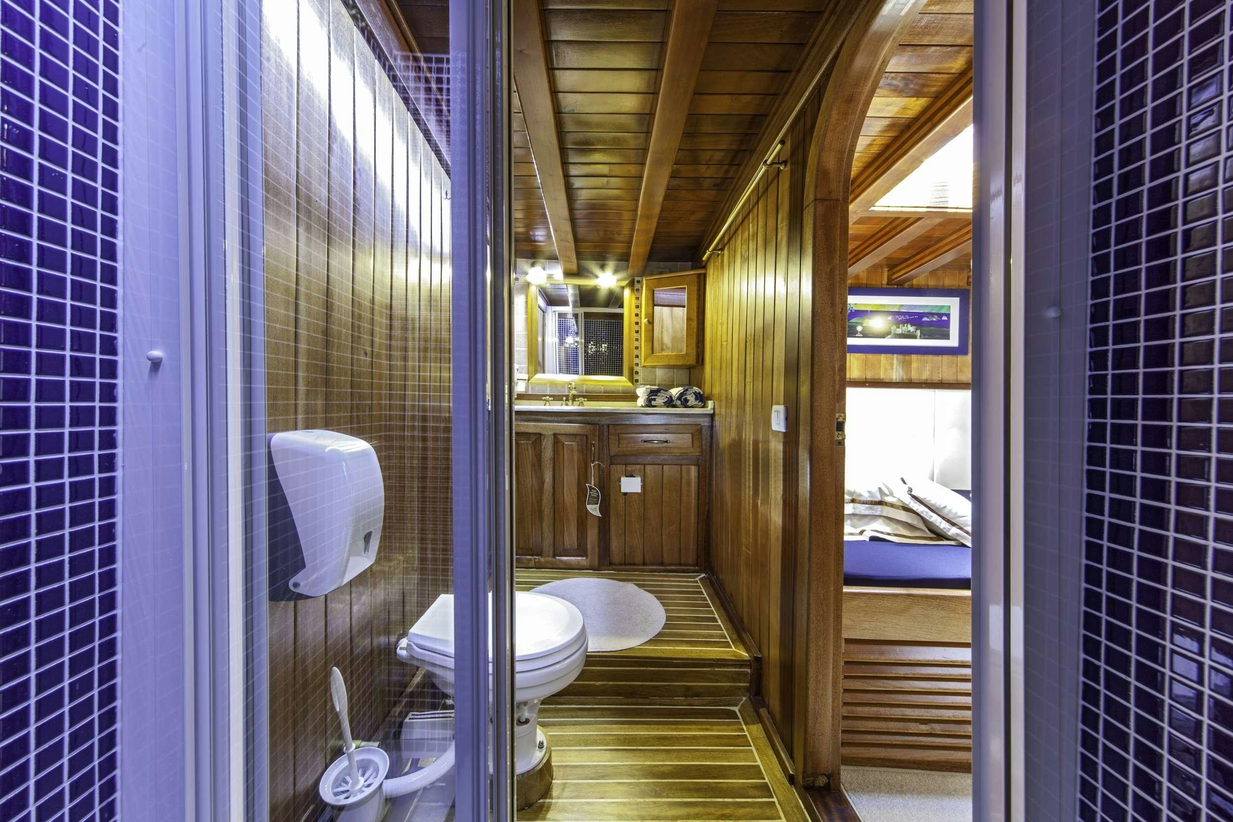 a bathroom with a glass shower aboard LIBRA Yacht for Charter