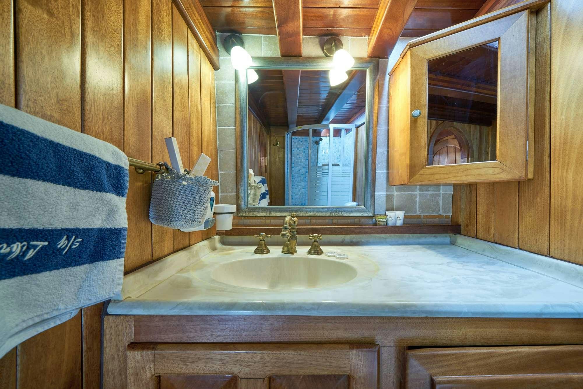 a bathroom with a sink and towels aboard LIBRA Yacht for Charter