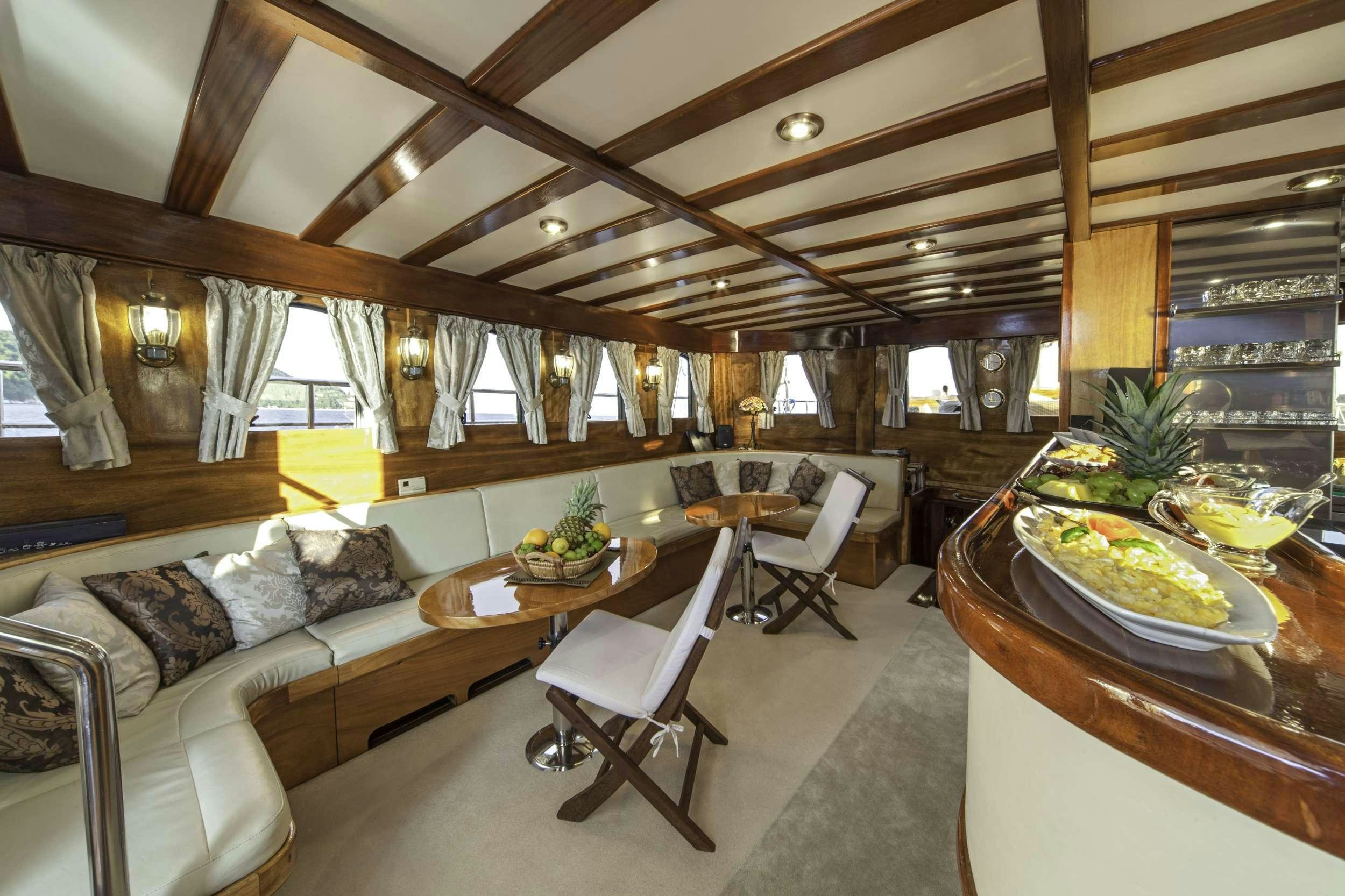 a living room with a couch and a table aboard LIBRA Yacht for Charter