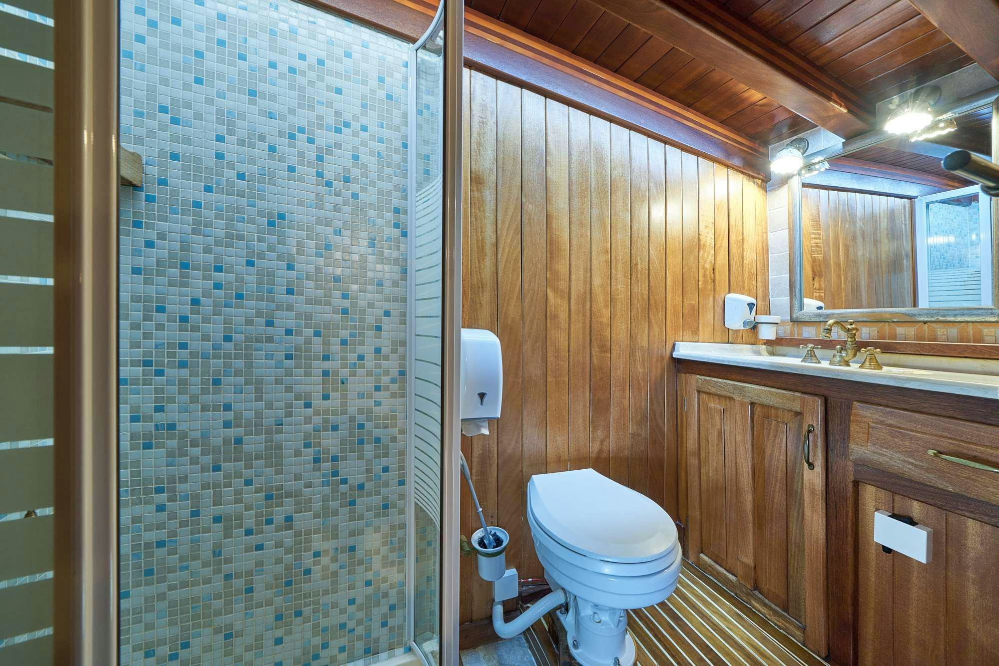 a bathroom with a glass shower aboard LIBRA Yacht for Charter