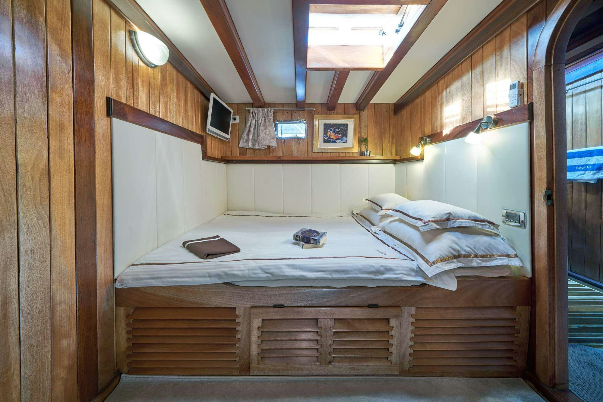 a bed in a room aboard LIBRA Yacht for Charter