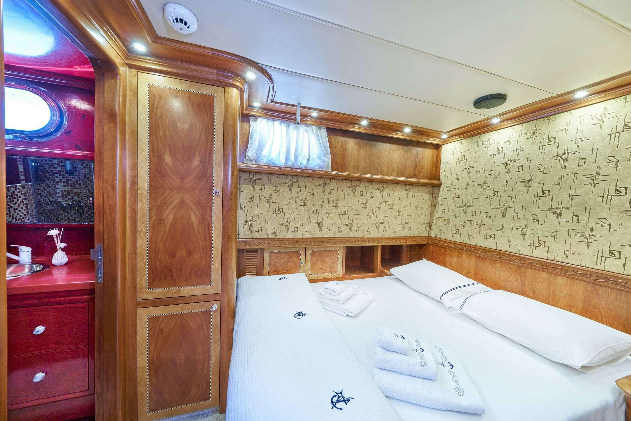 a room with a bed and a door aboard LOTUS Yacht for Charter